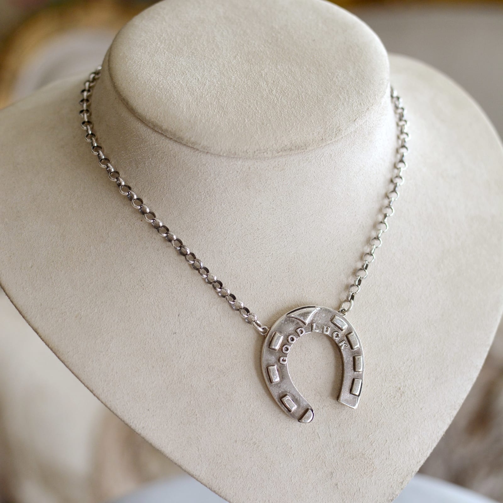 Jill Garber, A fabulous original heavyweight sterling silver cast horseshoe reading in raised letter across the top arch “ Good Luck”, with solid sterling silver oval rolo chain