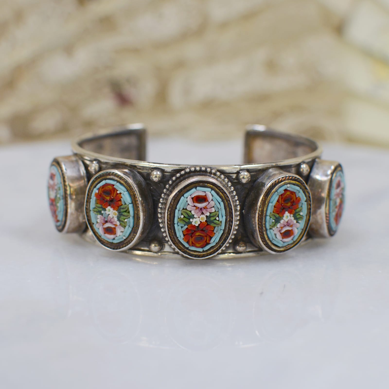 Jill Garber, EMBOSSED FLORAL CUFF WITH FIVE EARLY TWENTIETH CENTURY VENETIAN MICRO MOSAIC MEDALLIONS