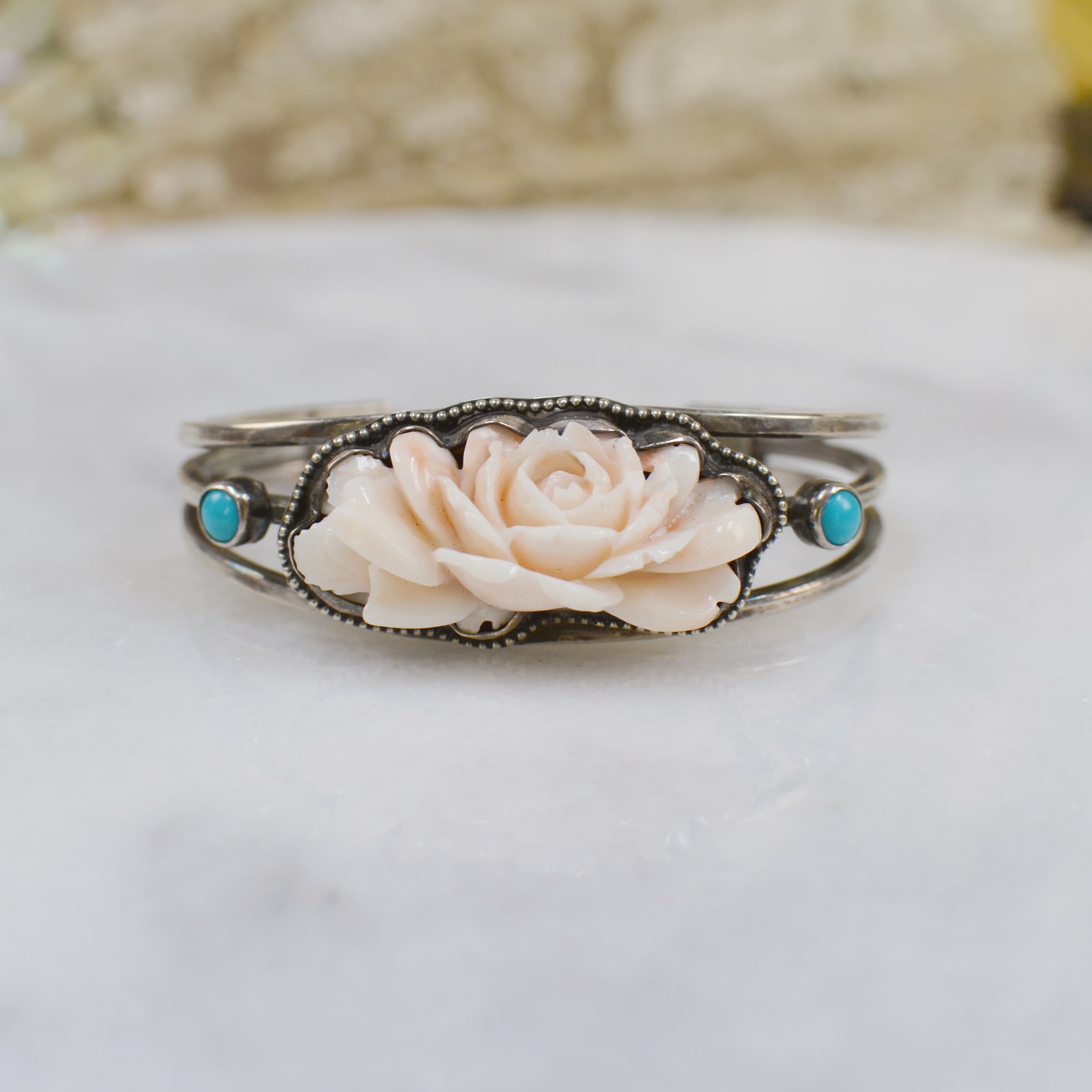 Jill Garber, FINELY CARVED EARLY TWENTIETH CENTURY ANGEL SKIN CORAL CUFF WITH SLEEPING BEAUTY TURQUOISE