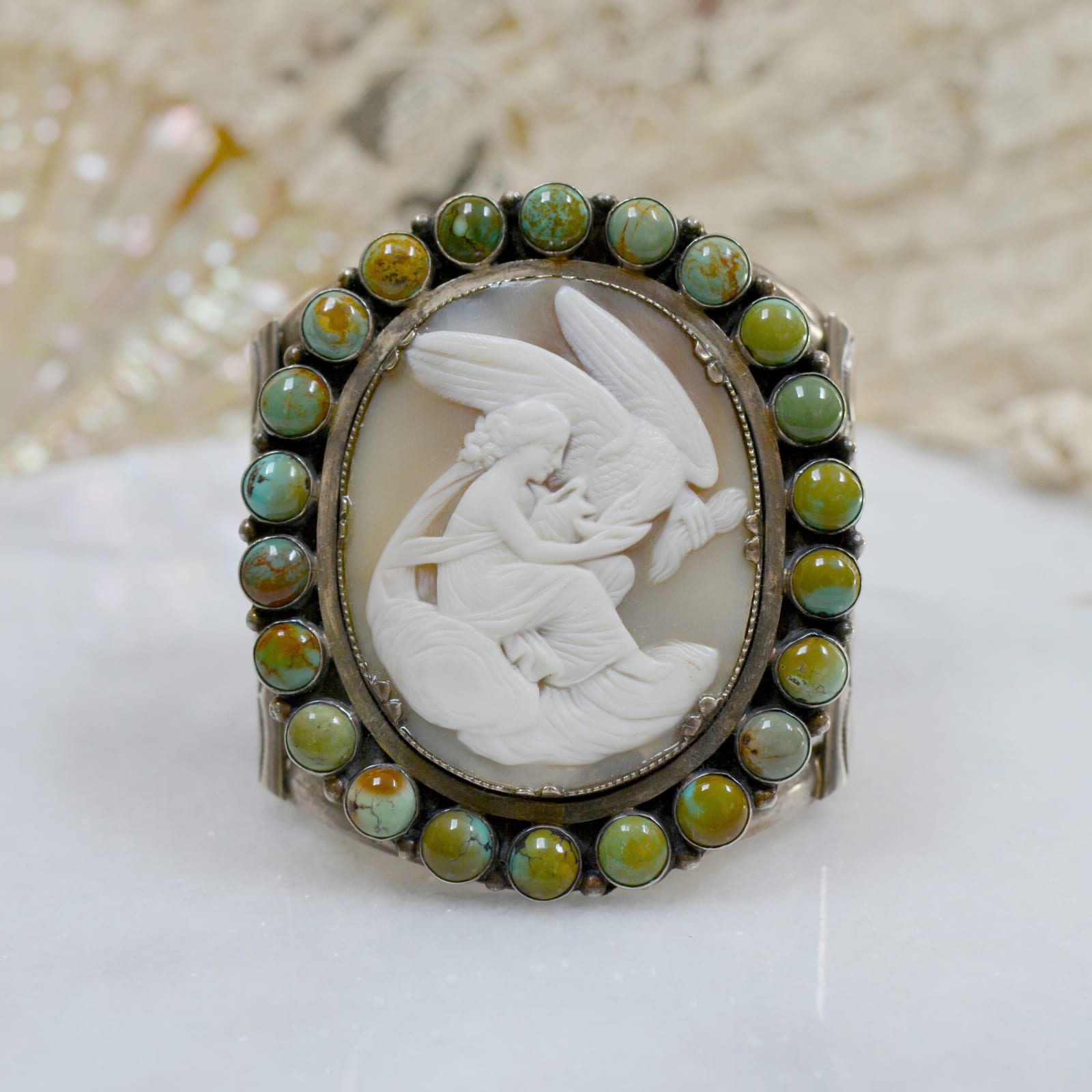 Jill Garber, Very fine 19th Century hand carved cameo depicting leda and the swan cameo surrounded with rosemary green Royston turquoise cabochons