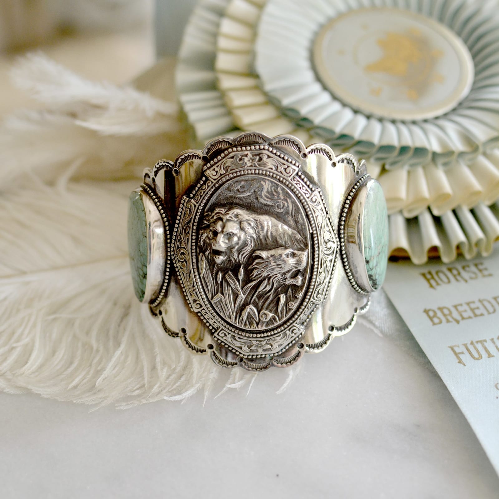 Jill Garber, Elegant wide hand forged English repousse Lion and Lioness cuff with aqua blue turquoise cabochons and hand stamped lice like details