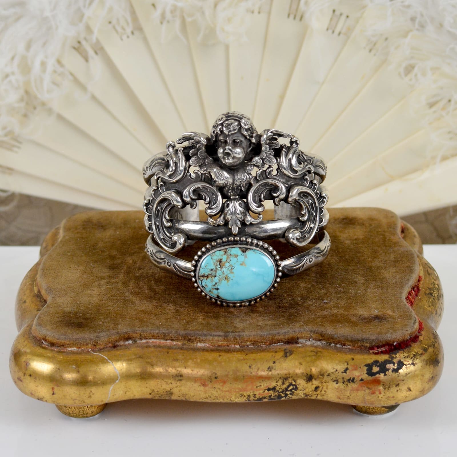 Jill Garber, FIGURAL ANGEL CAST WITH ORNATE WINGS BELOW, TURQUOISE CENTER