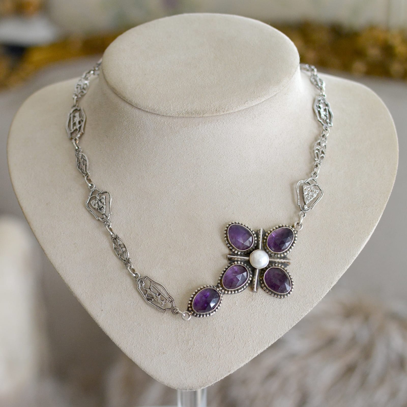 Jill Garber, Jill Garber’s original design as an off-center cross necklace suspended on her original complex figural chaining