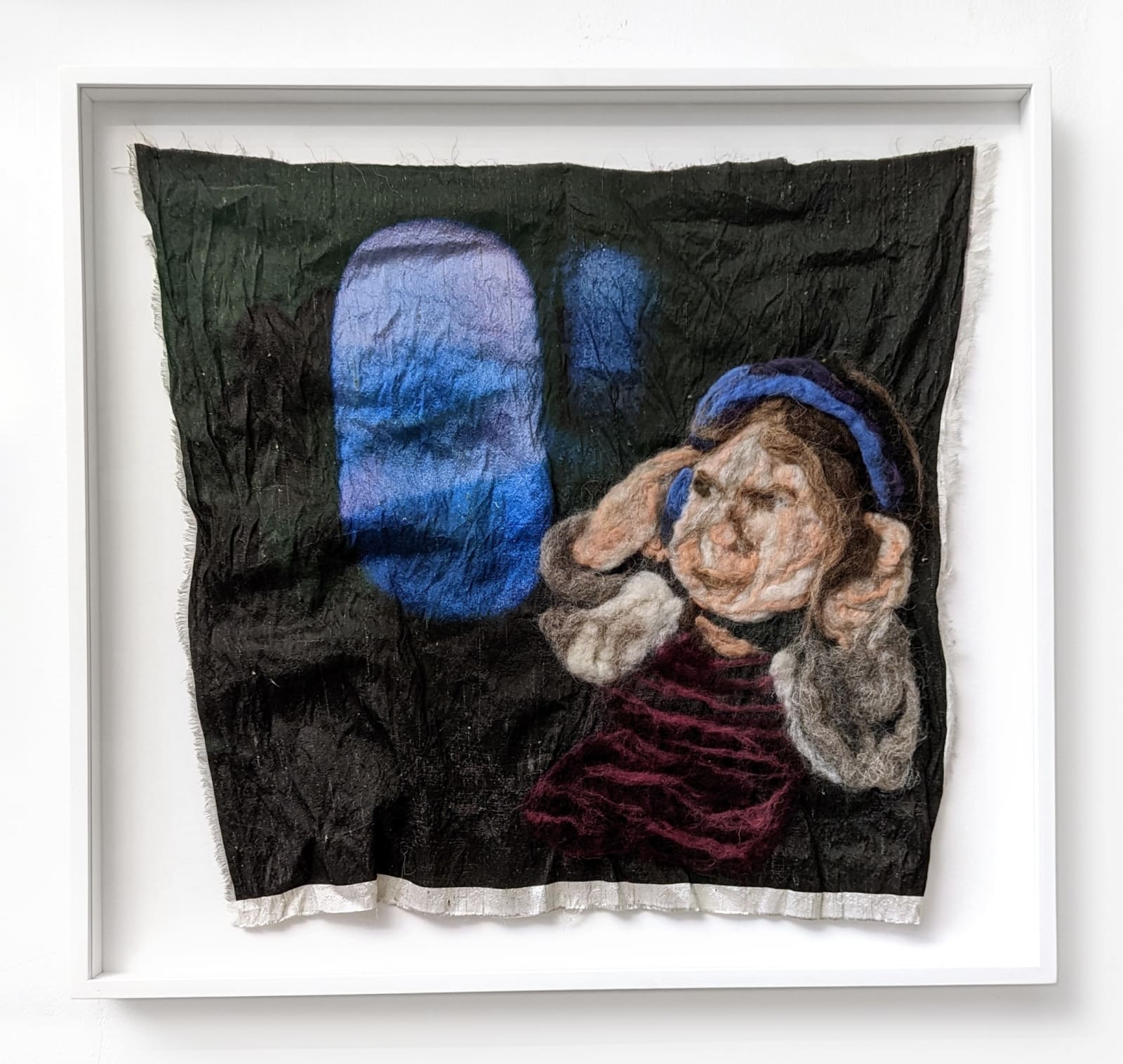 Textile artwork by Melissa Joseph of a young child looking out an airplane window