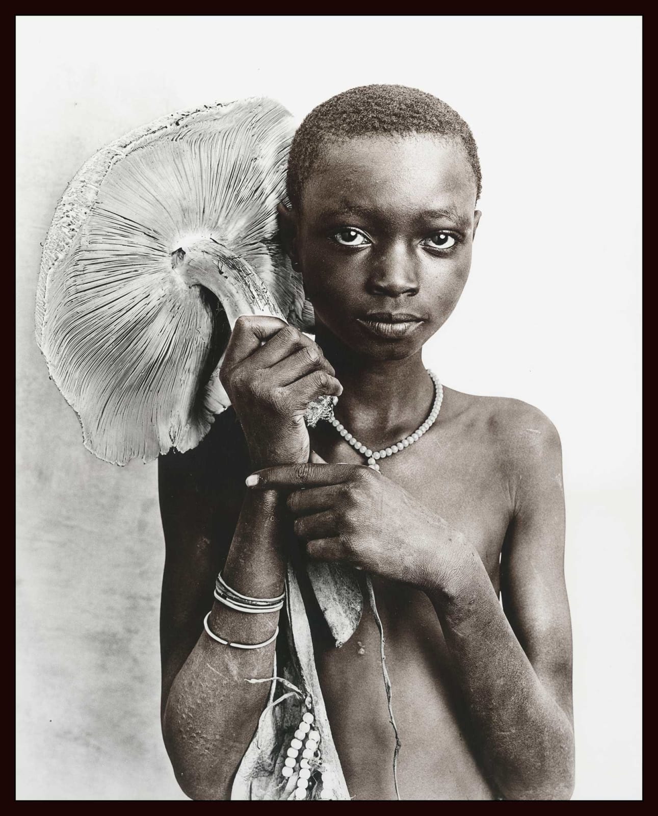 Jan C. Schlegel, Suri tribe girl with mushroom, Ethiopia, 2017
