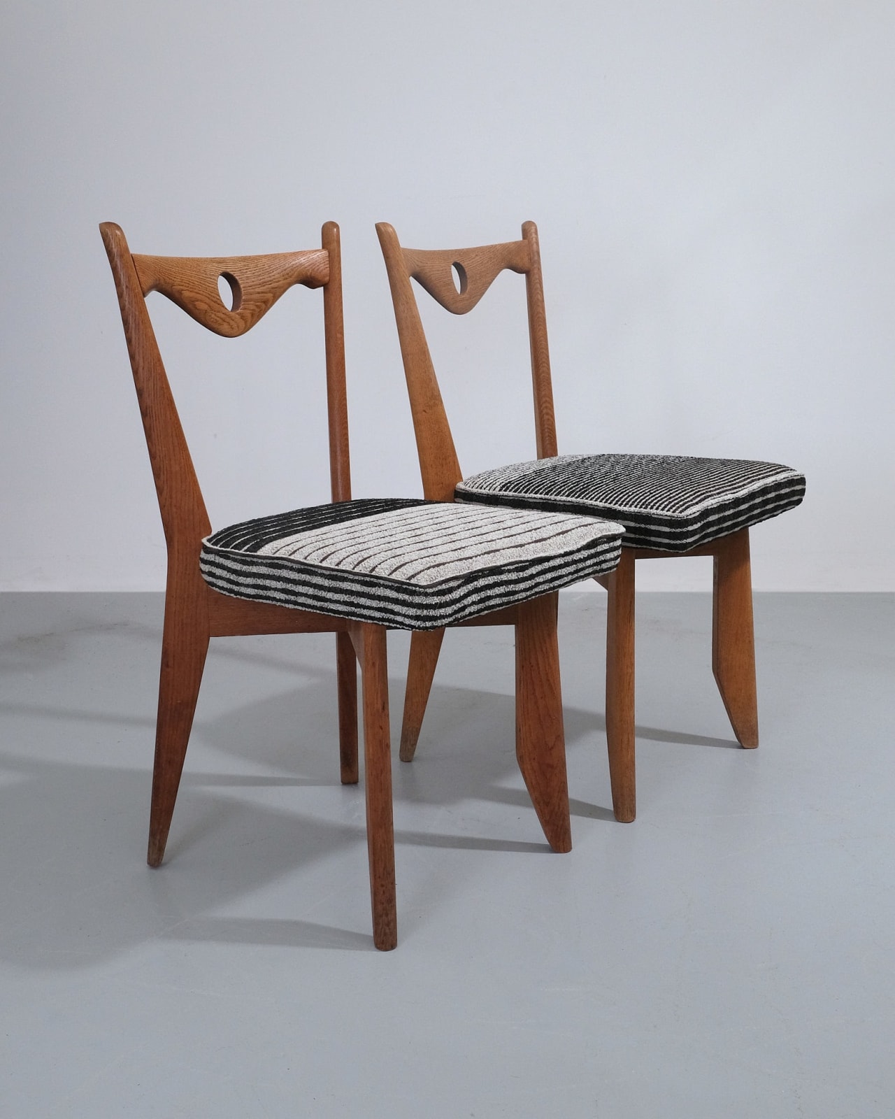 Guillerme et Chambron, Set of Four Dining Chairs With Circular Cut-out Detail