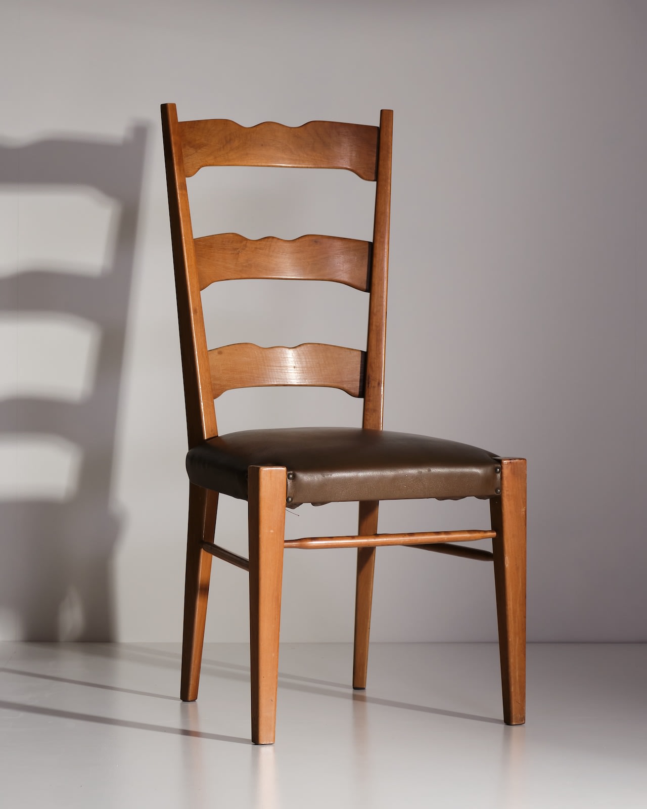 Osvaldo Borsani, Eight wooden chairs with skai upholstery