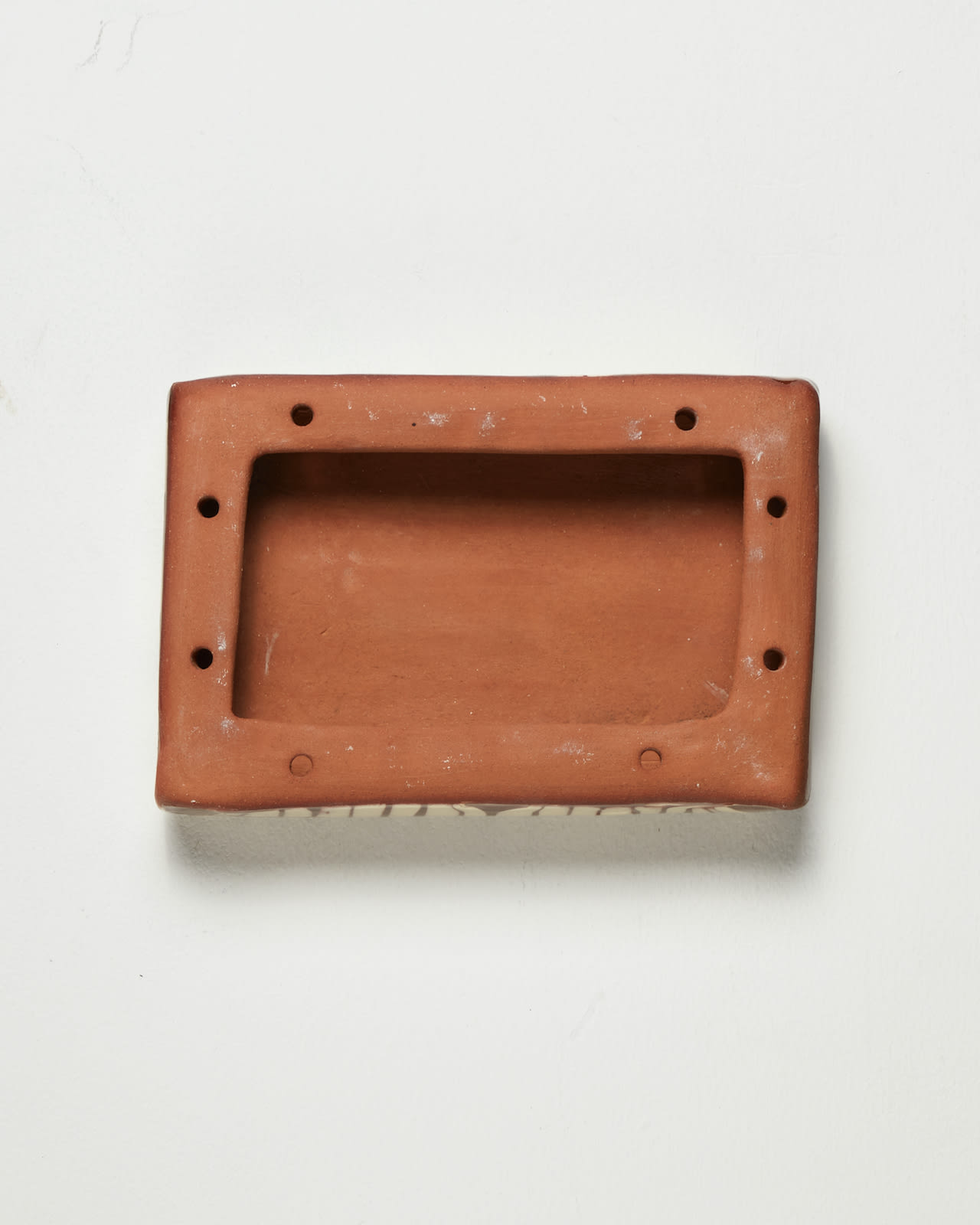 Nicola Tassie, Slip pillow feathering cream slip on terracotta