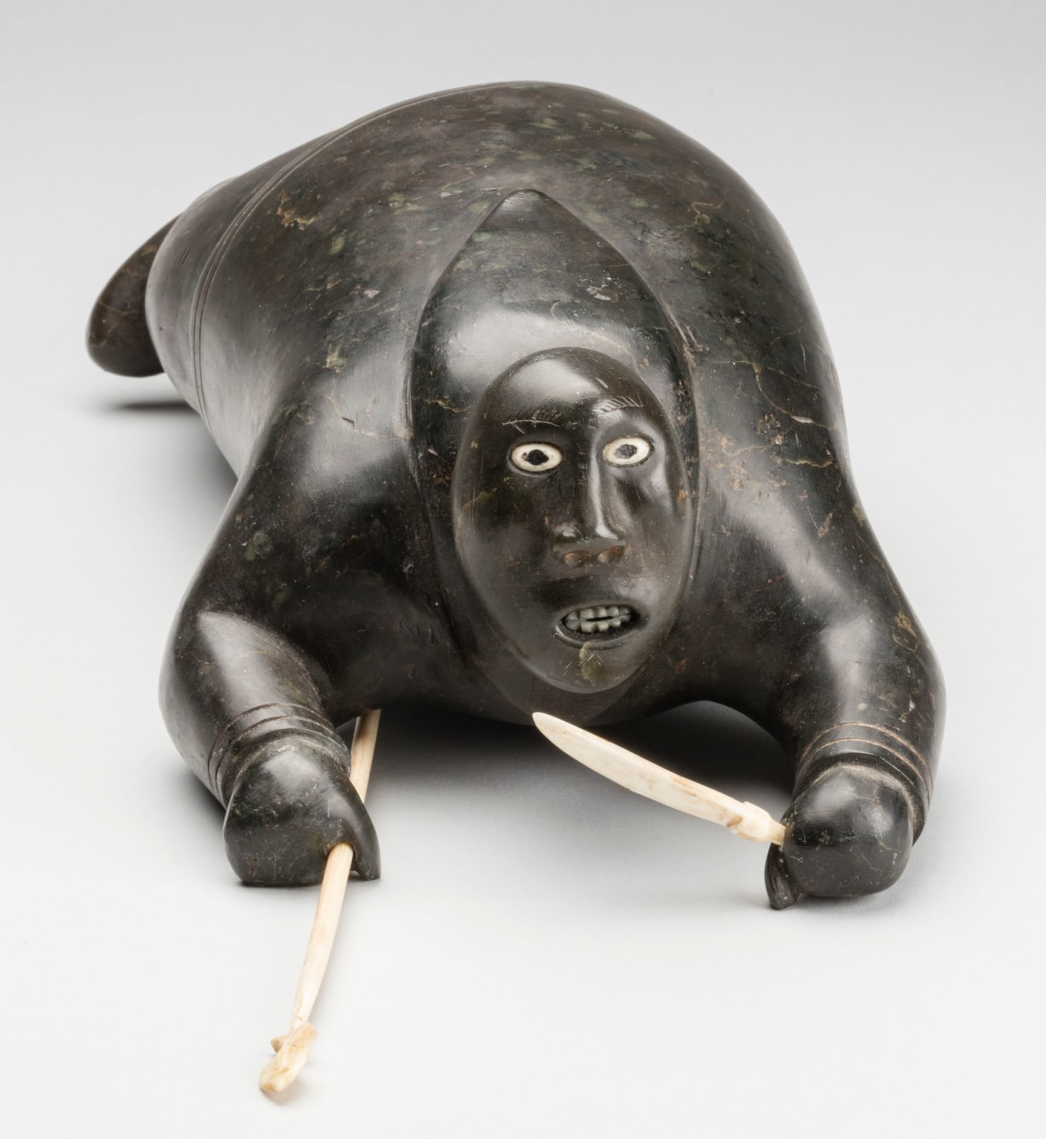 Attributed to JOHNNY INUKPUK, R.C.A (1911-2007) INUKJUAK (PORT HARRISON), Crawling Hunter with Knife and Spear, c. 1952