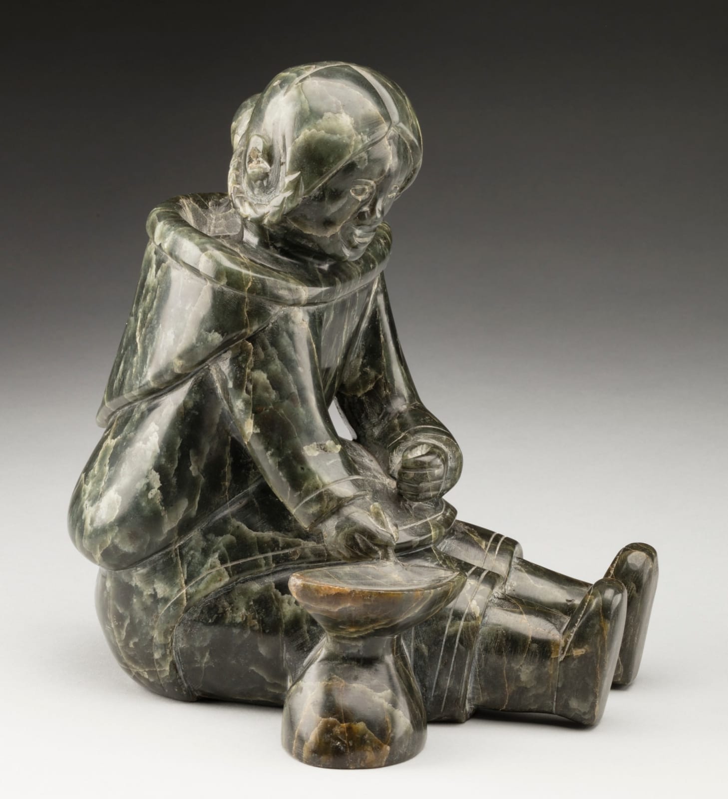 MANNUMI SHAQU (1917-2000) KINNGAIT (CAPE DORSET), Mother and Child, Tending a Qulliq, c. 1953-54