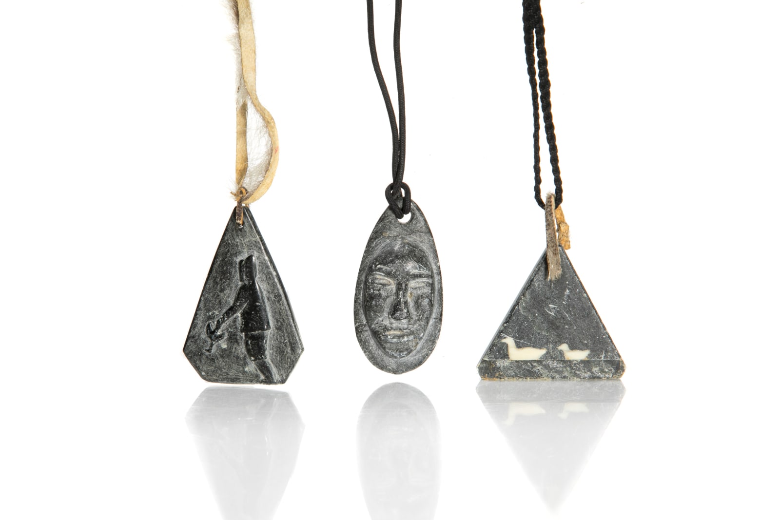 JAMASIE MIKE (1928-) PANNIRTUQ (PANGNIRTUNG), MOSES AUPALUKTIK (1924-1983) PUVIRNITUQ (POVUNGNITUK), and JOSEPHEE KILABUK (1934-) PANNIRTUQ (PANGNIRTUNG), Three Pendants , mid-late 1960s & 1968