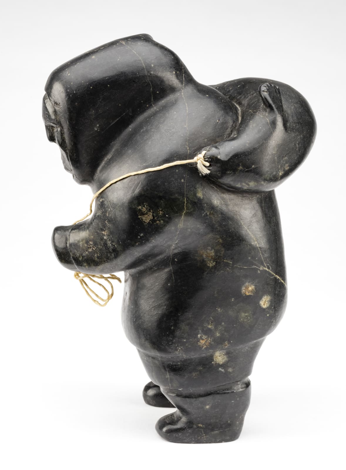 AKEEAKTASHUK (1898-1954) INUKJUAK (PORT HARRISON), Hunter Carrying a Captured Seal, c. 1951-53