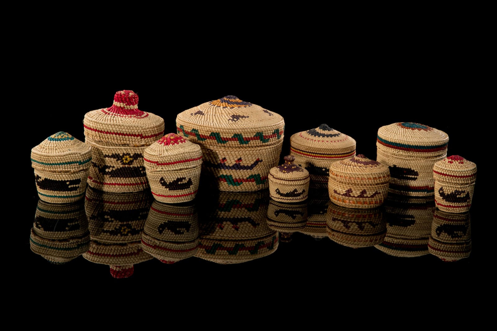 UNIDENTIFIED NUU-CHAH-NULTH ARTISTS, Group of Nine Lidded Pictorial Baskets, mid 1980s or later