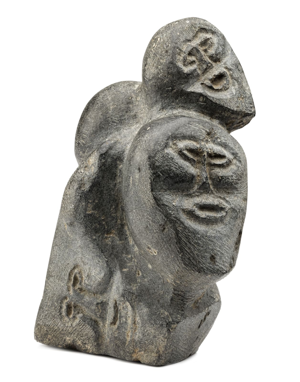 JOHN TIKTAK, R.C.A. (1916-1981) KANGIQLINIQ (RANKIN INLET), Heads Emerging from Stone, c. 1967