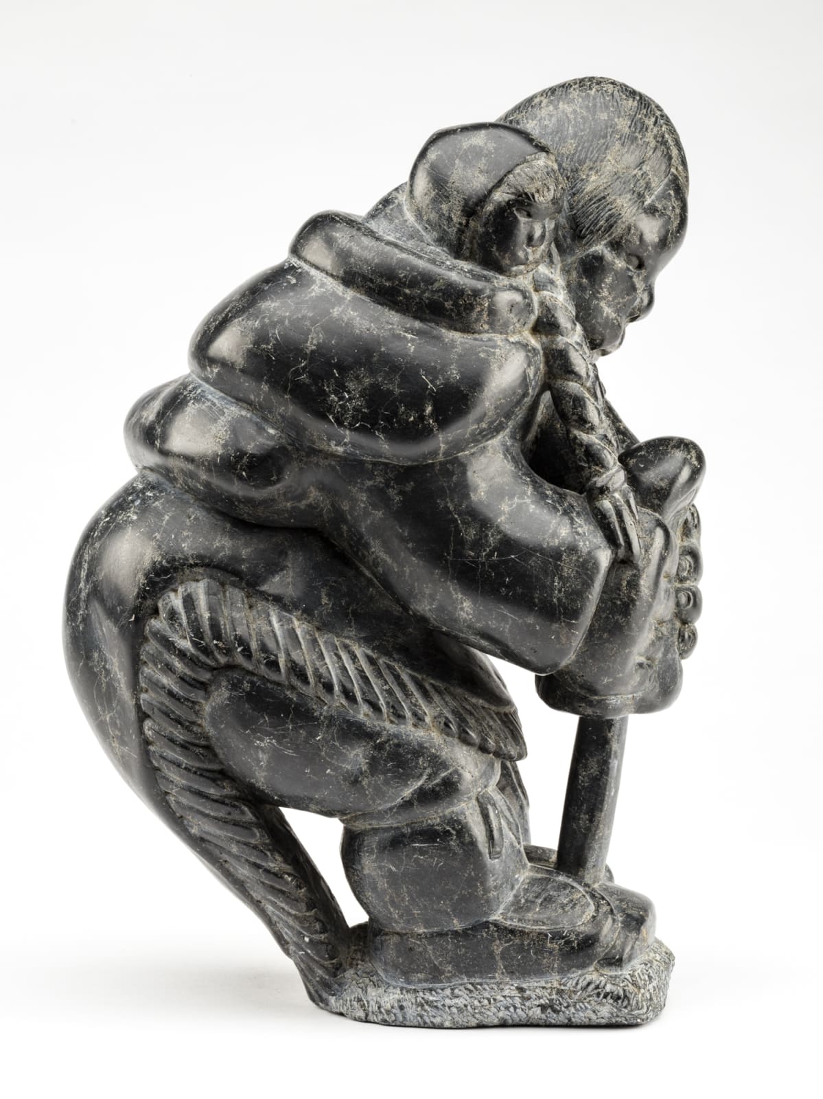 JOHNNY INUKPUK, R.C.A. (1911-2007) INUKJUAK (PORT HARRISON), Mother with Child, Stretching a Kamik, early 1960s