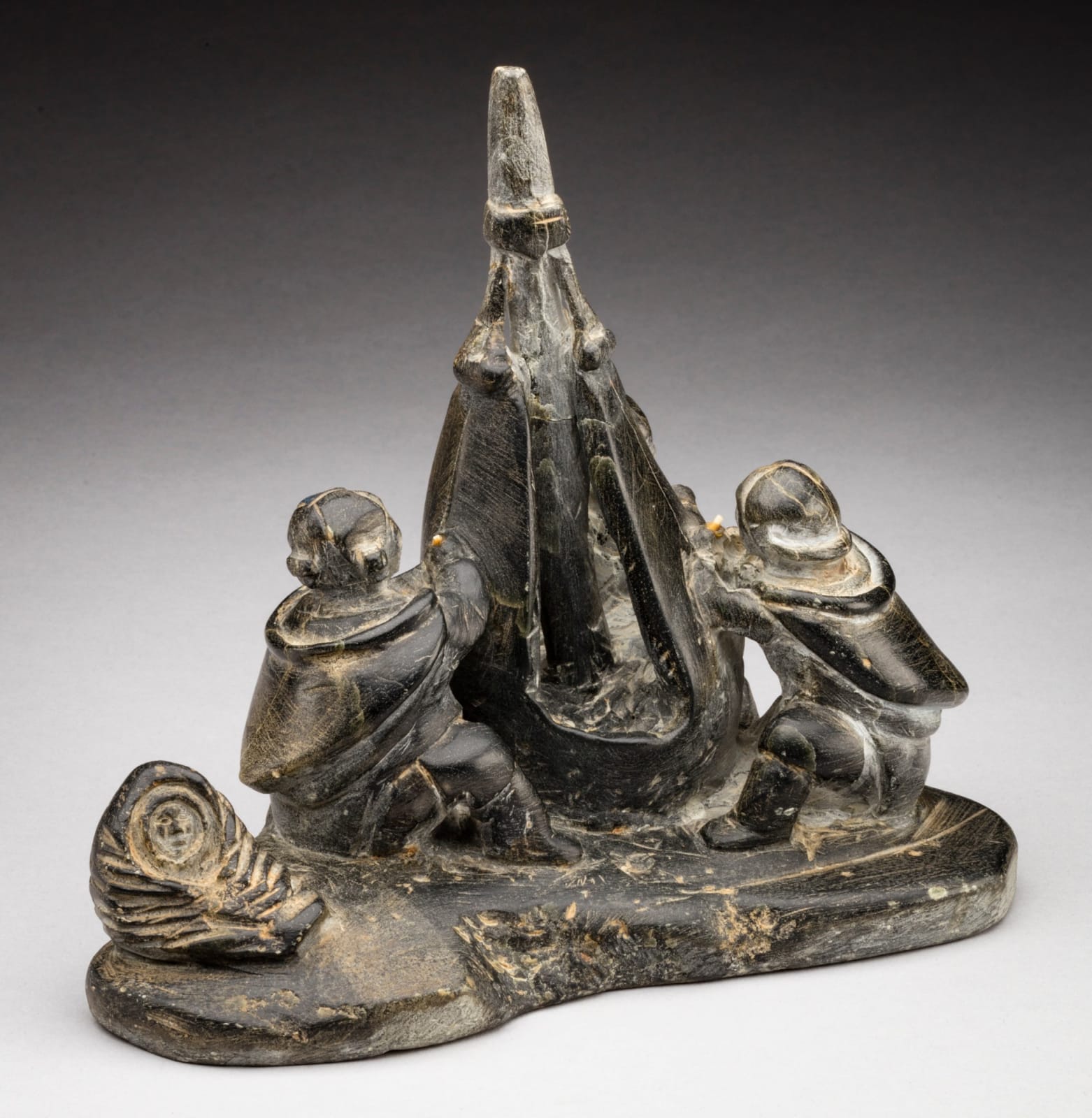 ENNUTSIAK (1893-1967) IQALUIT (FROBISHER BAY), Women Sewing Skins for a Kayak, c. 1958-60