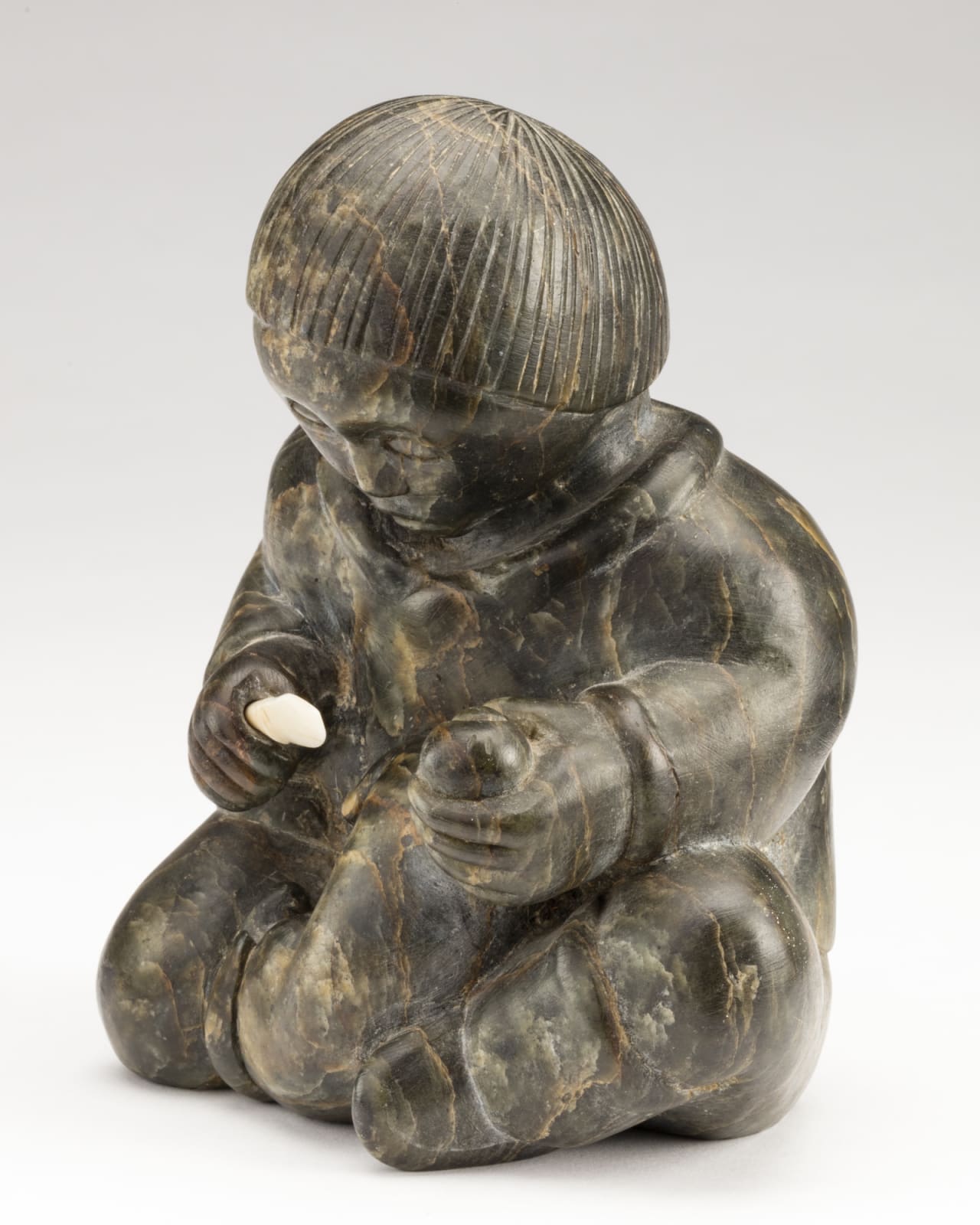 SIMON KASUDLUAK (1925-D) INUKJUAK (PORT HARRISON), Young Boy Skinning an Ermine, mid-late 1950s