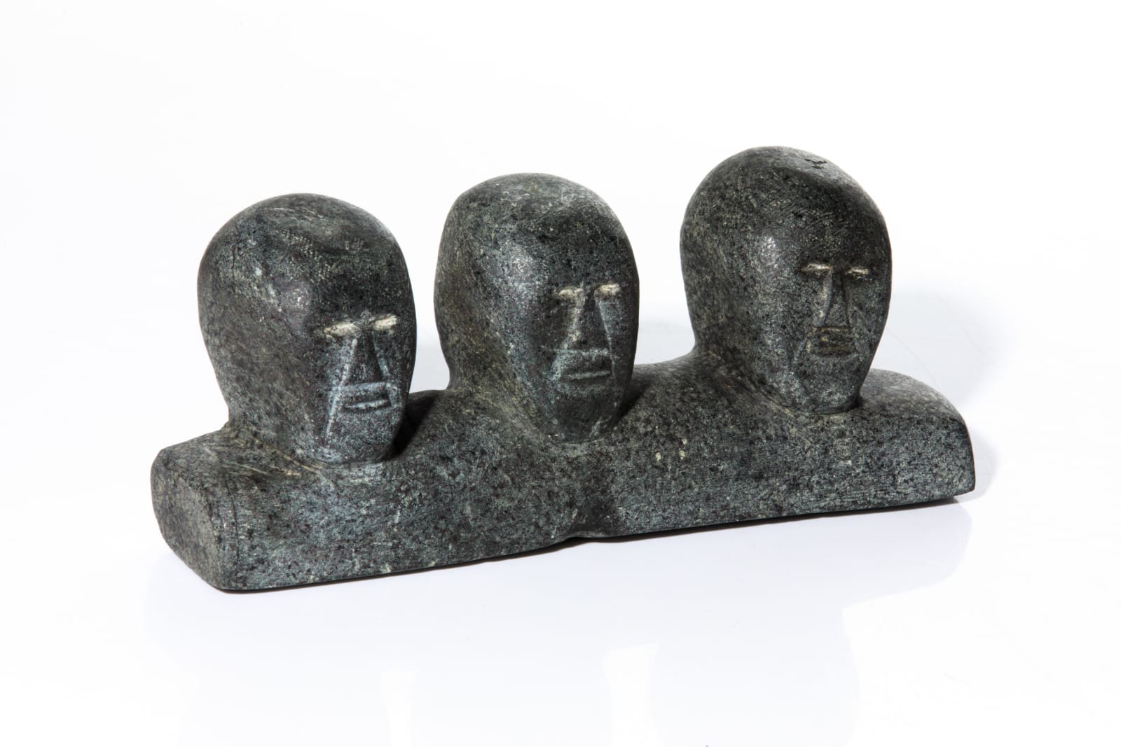 EVE UKANAK MUKYUNGNIK (1941-) ARVIAT (ESKIMO POINT), Bust of Three Men, c. 1975