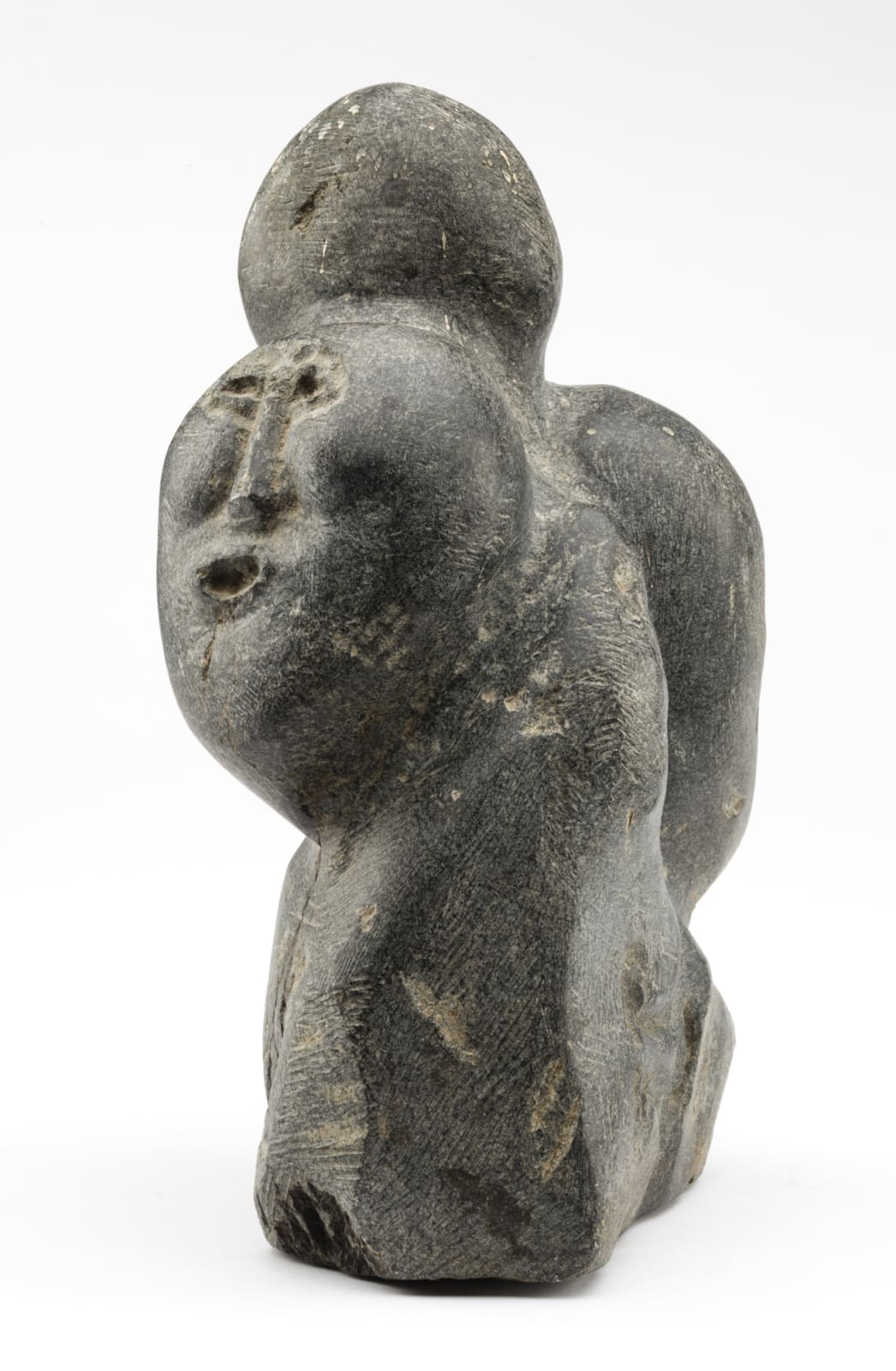 JOHN TIKTAK, R.C.A. (1916-1981) KANGIQLINIQ (RANKIN INLET), Heads Emerging from Stone, c. 1967