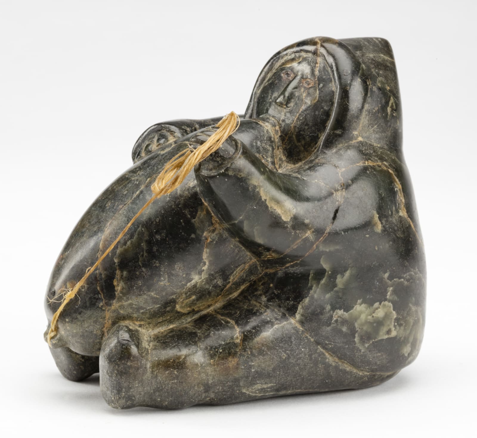 Possibly: ISA OOMAYOUALOOK (1915-1976) PORT HARRISON (INUKJUAK), Man Inflating an Avataq (Seal Skin Float), late 1950s