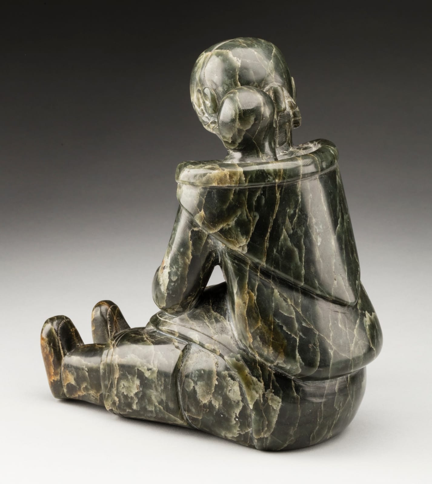 MANNUMI SHAQU (1917-2000) KINNGAIT (CAPE DORSET), Mother and Child, Tending a Qulliq, c. 1953-54