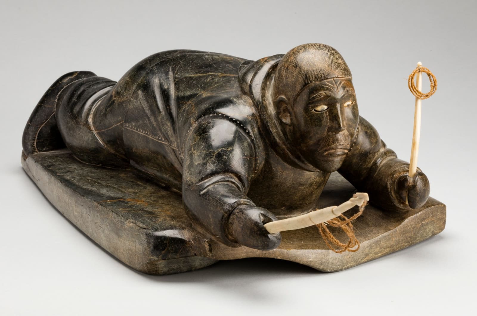 ISAH QUMALU SIVUARAPI (1925-1979) PUVIRNITUQ (POVUNGNITUK), Crawling Hunter with Harpoon and Line, late 1950s