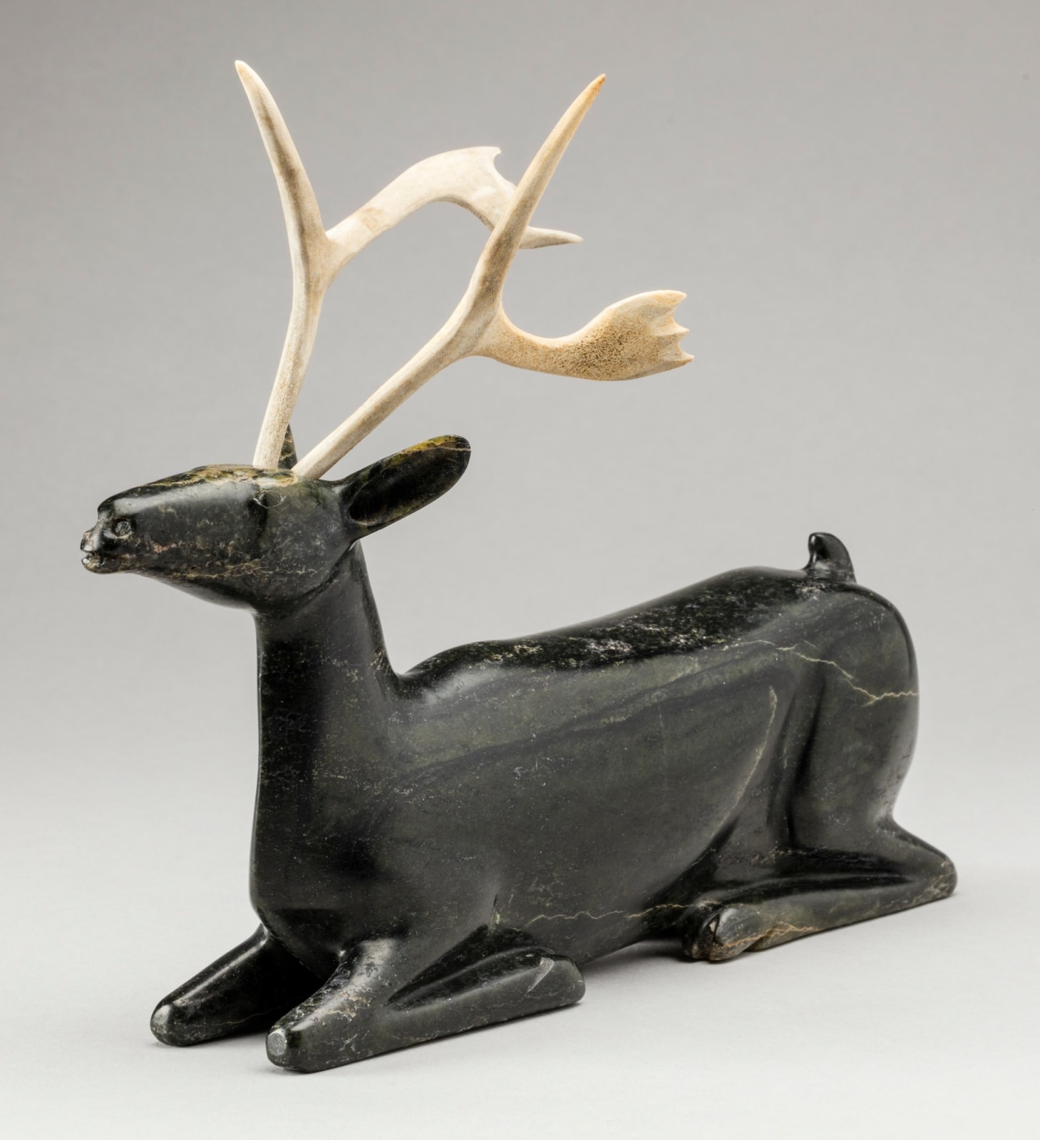 OSUITOK IPEELEE, R.C.A. (1922 or 1923-2005) KINNGAIT (CAPE DORSET, Resting Caribou, c. 1988-89