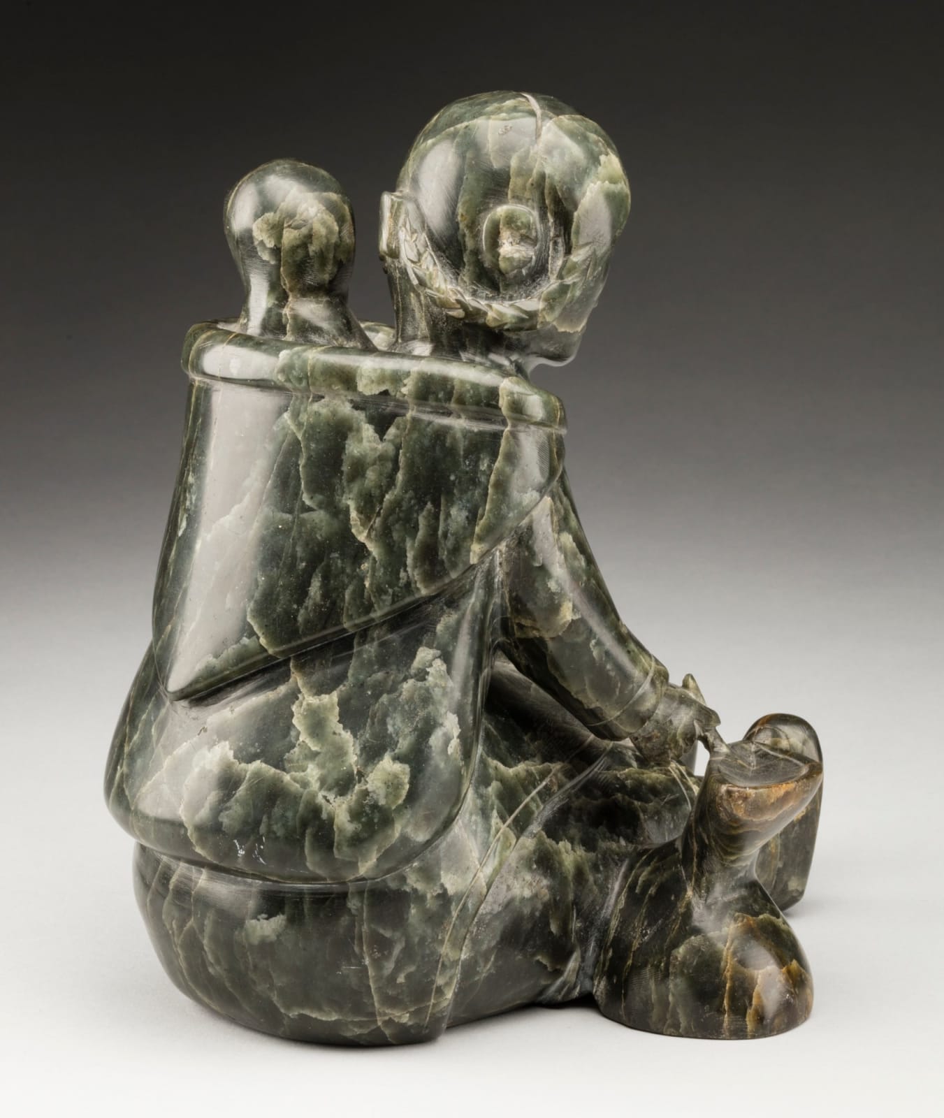 MANNUMI SHAQU (1917-2000) KINNGAIT (CAPE DORSET), Mother and Child, Tending a Qulliq, c. 1953-54