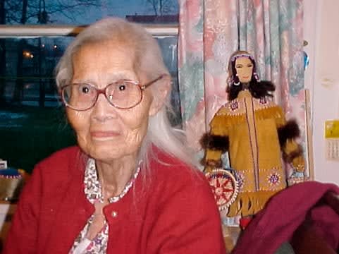 ELLEN SAVAGE (ELLEN SAVAGE XIDHOY) (1919-2004) DEG XINAG ATHABASCAN, Athabaskan Doll with Beaded Coat and Willow Root Basket, 12 Sept 2001