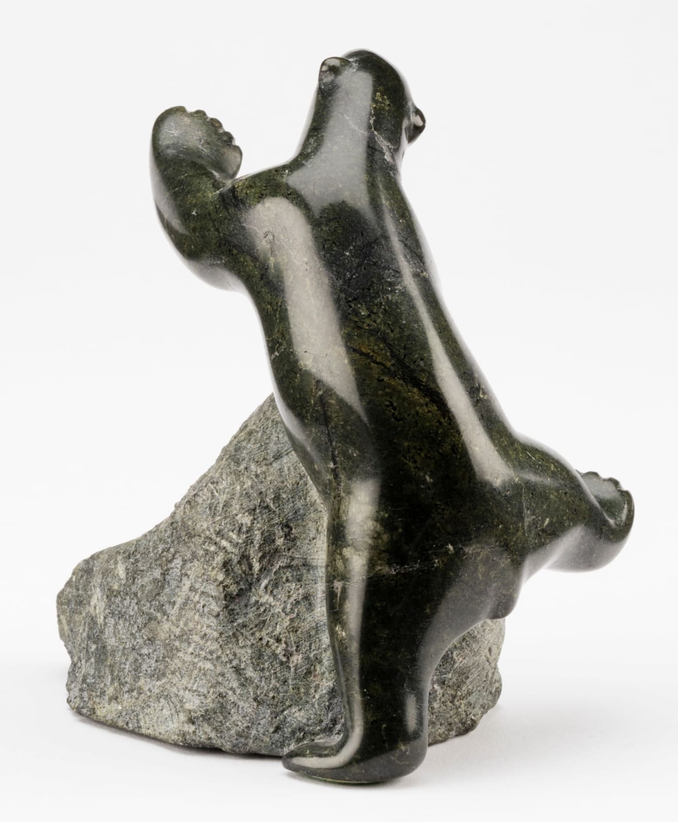 HENRY EVALUARDJUK (1923-2007) IQALUIT (FROBISHER BAY), Bear Climbing a Boulder, late 1970s