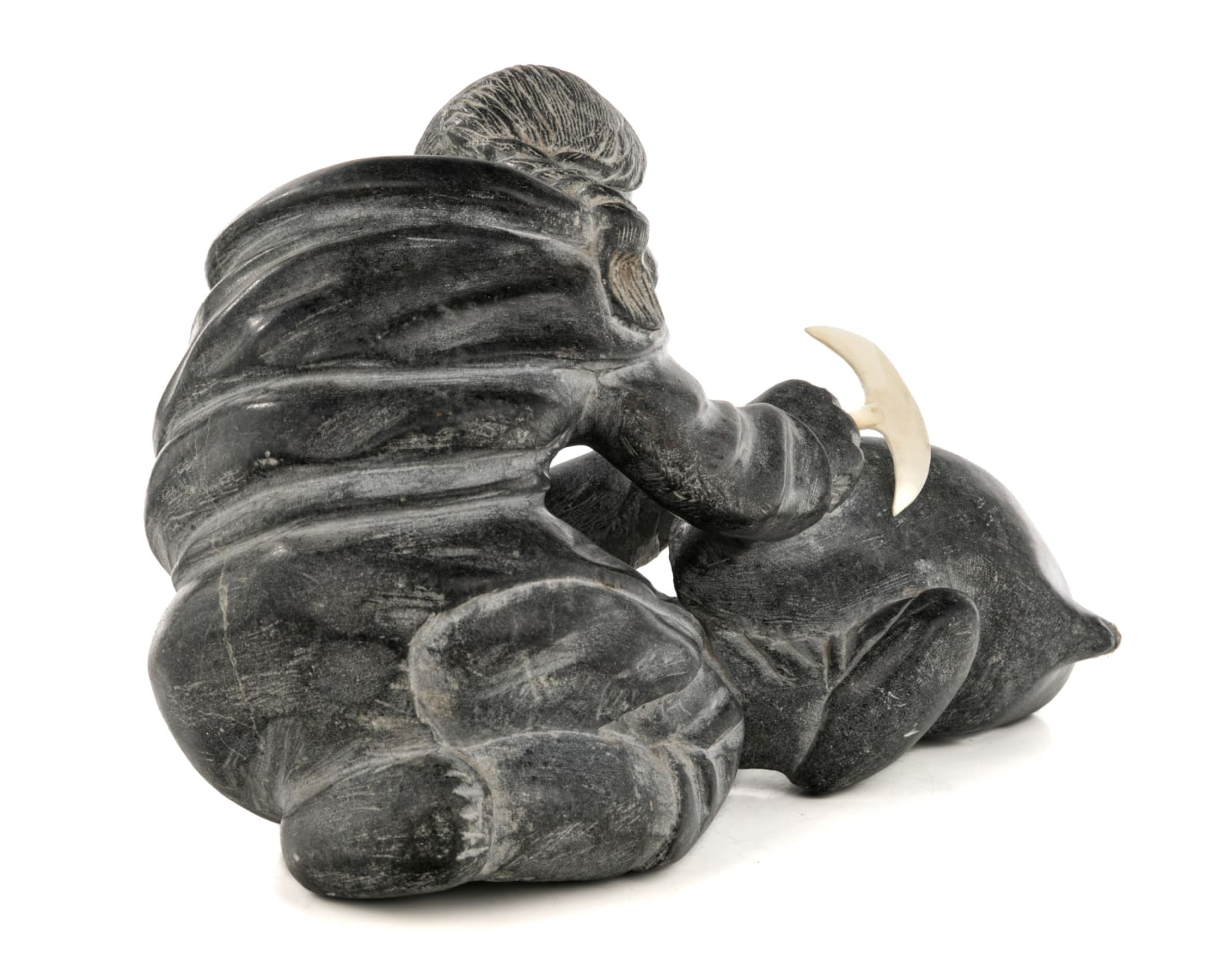 AUDLALUK KUPIRKRUALUK (1926-D) SALLUIT (SUGLUK), Woman Cutting Up an Avataq, early 1960s