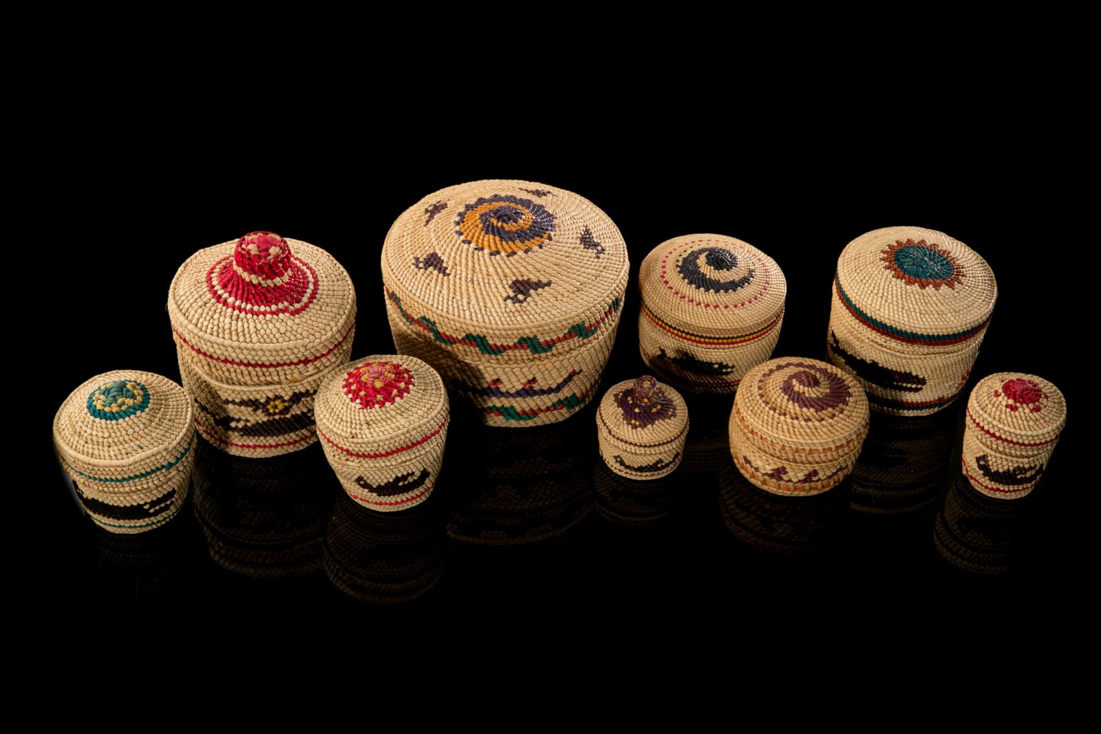 UNIDENTIFIED NUU-CHAH-NULTH ARTISTS, Group of Nine Lidded Pictorial Baskets, mid 1980s or later