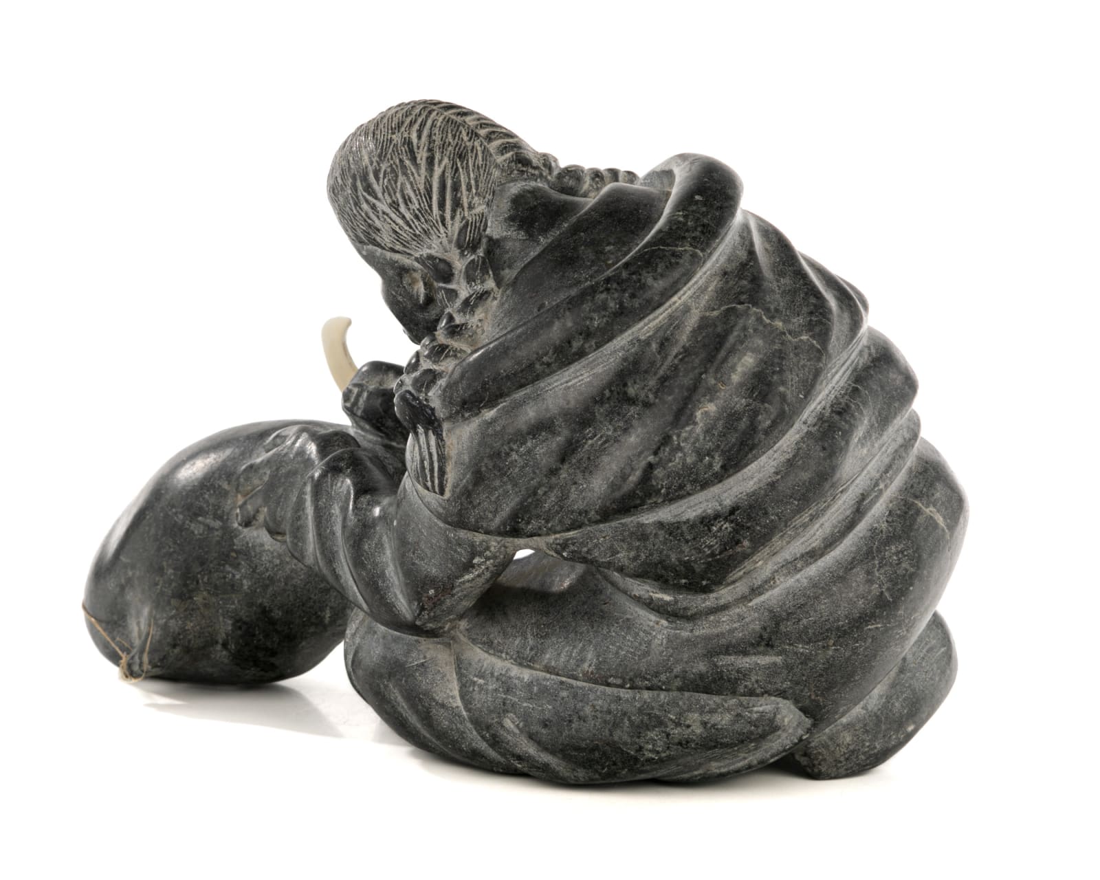 AUDLALUK KUPIRKRUALUK (1926-D) SALLUIT (SUGLUK), Woman Cutting Up an Avataq, early 1960s