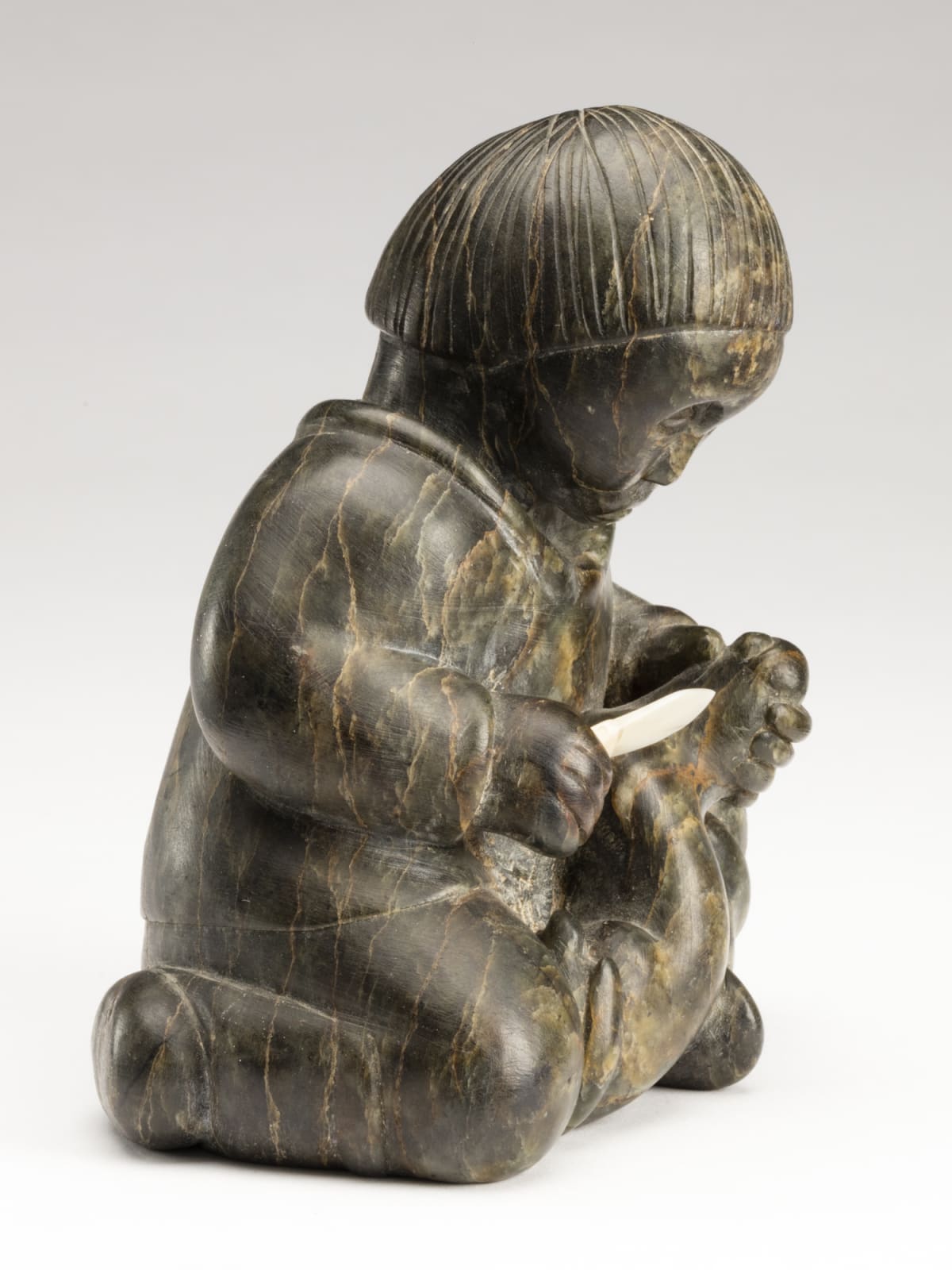 SIMON KASUDLUAK (1925-D) INUKJUAK (PORT HARRISON), Young Boy Skinning an Ermine, mid-late 1950s