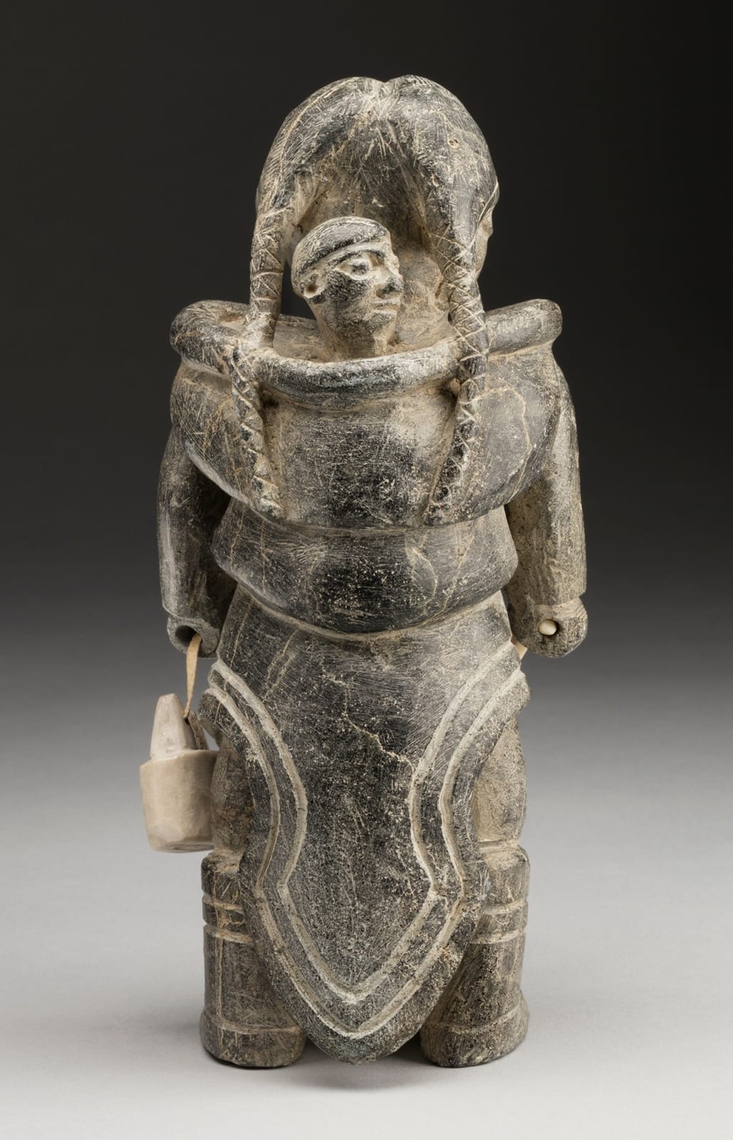 JOE TALIRUNILI (1893-1976) PUVIRNITUQ (POVUNGNITUK), Mother and Child, with Pail and Ulu, late 1960s