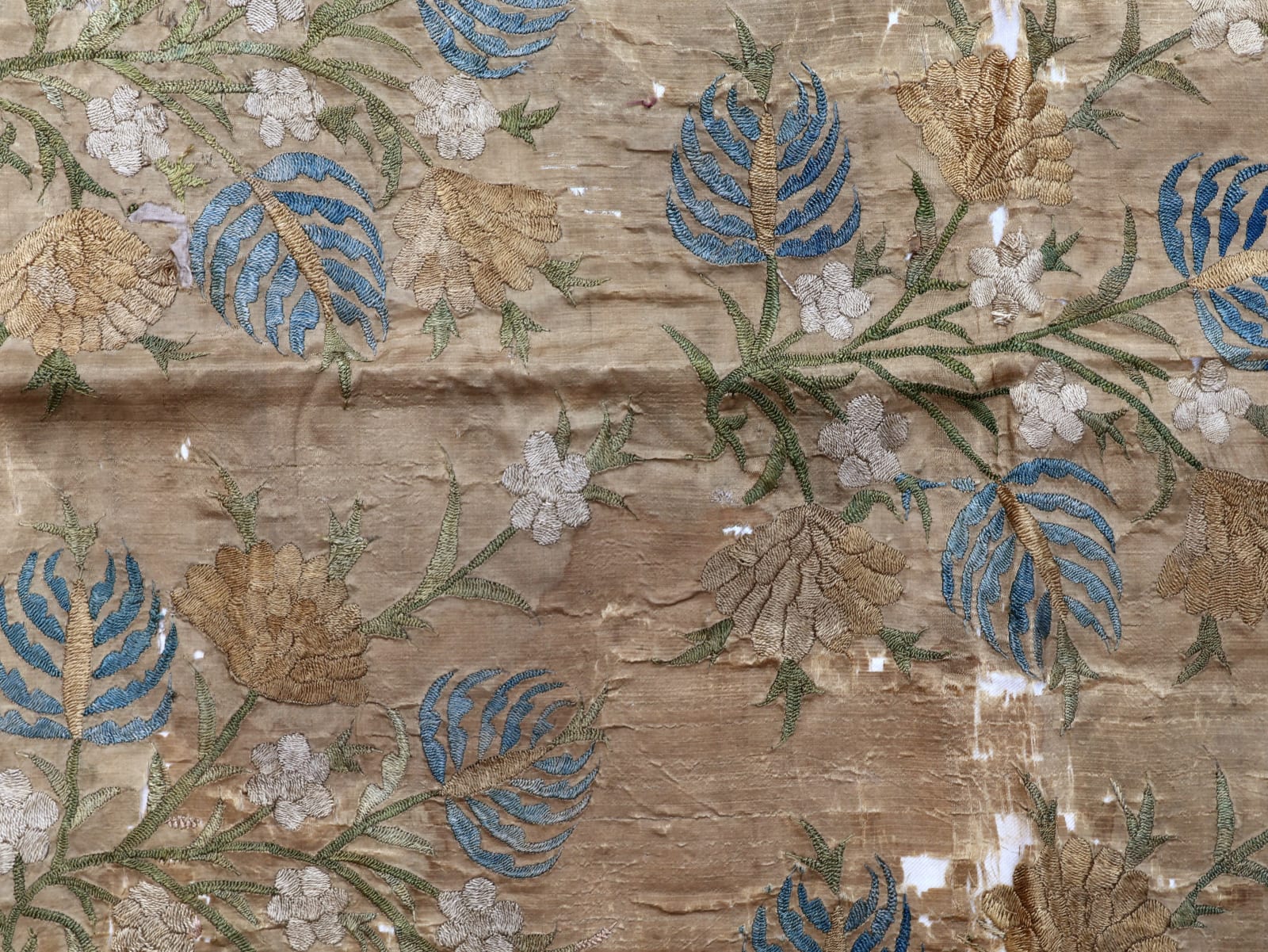 Fragment of embroidery, green, blue and cream taffeta with sprays of flowers