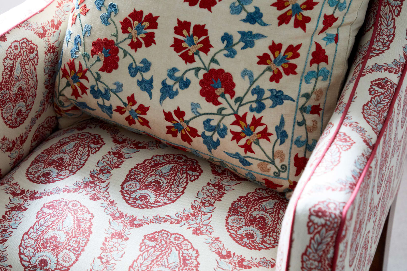 Chair upholstered in Susan Deliss Padishah linen in red blue cream