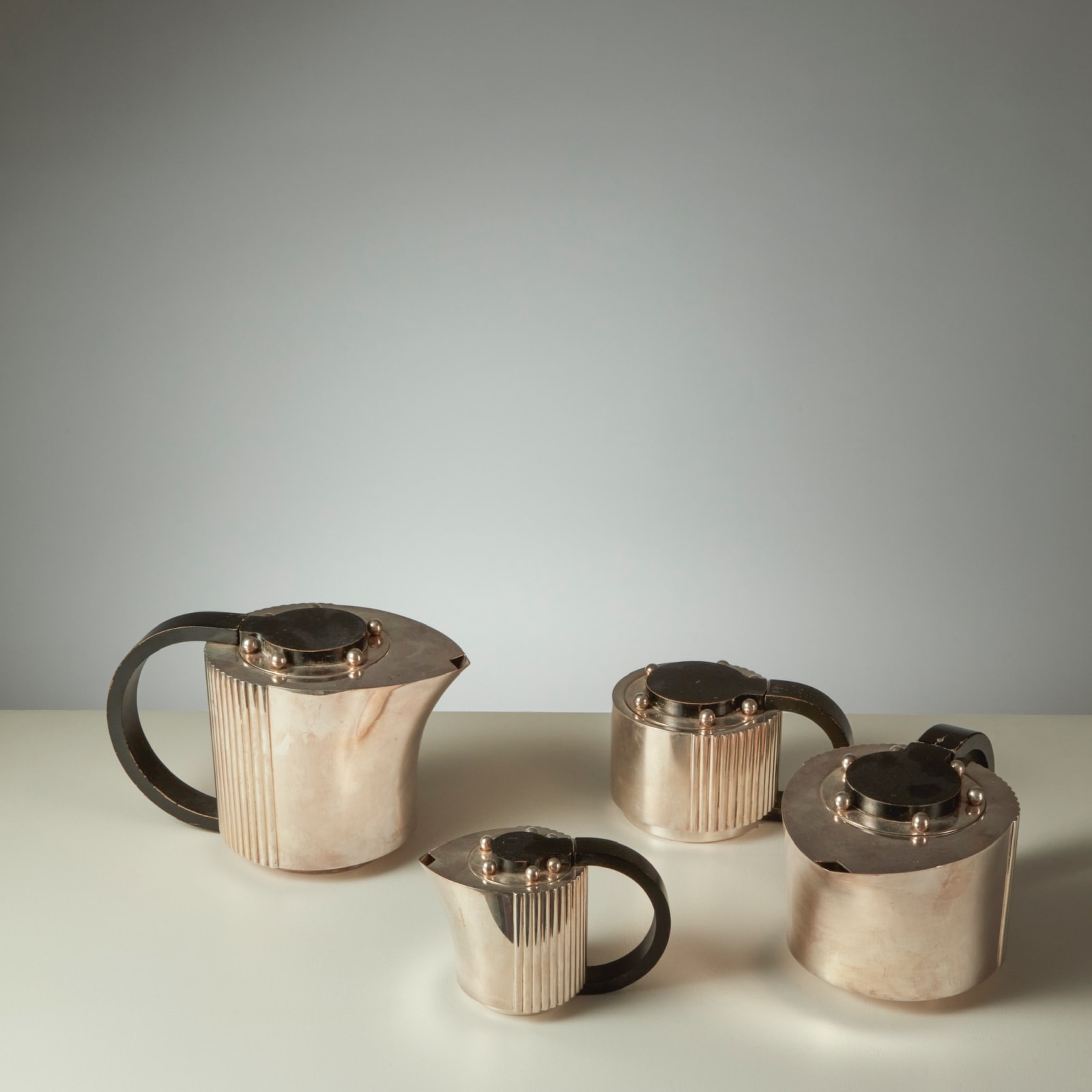 JEAN PUIFORCAT, FOUR-PIECE 'ETCHÉA' TEA SERVICE ON THE TRAY, c. 1937