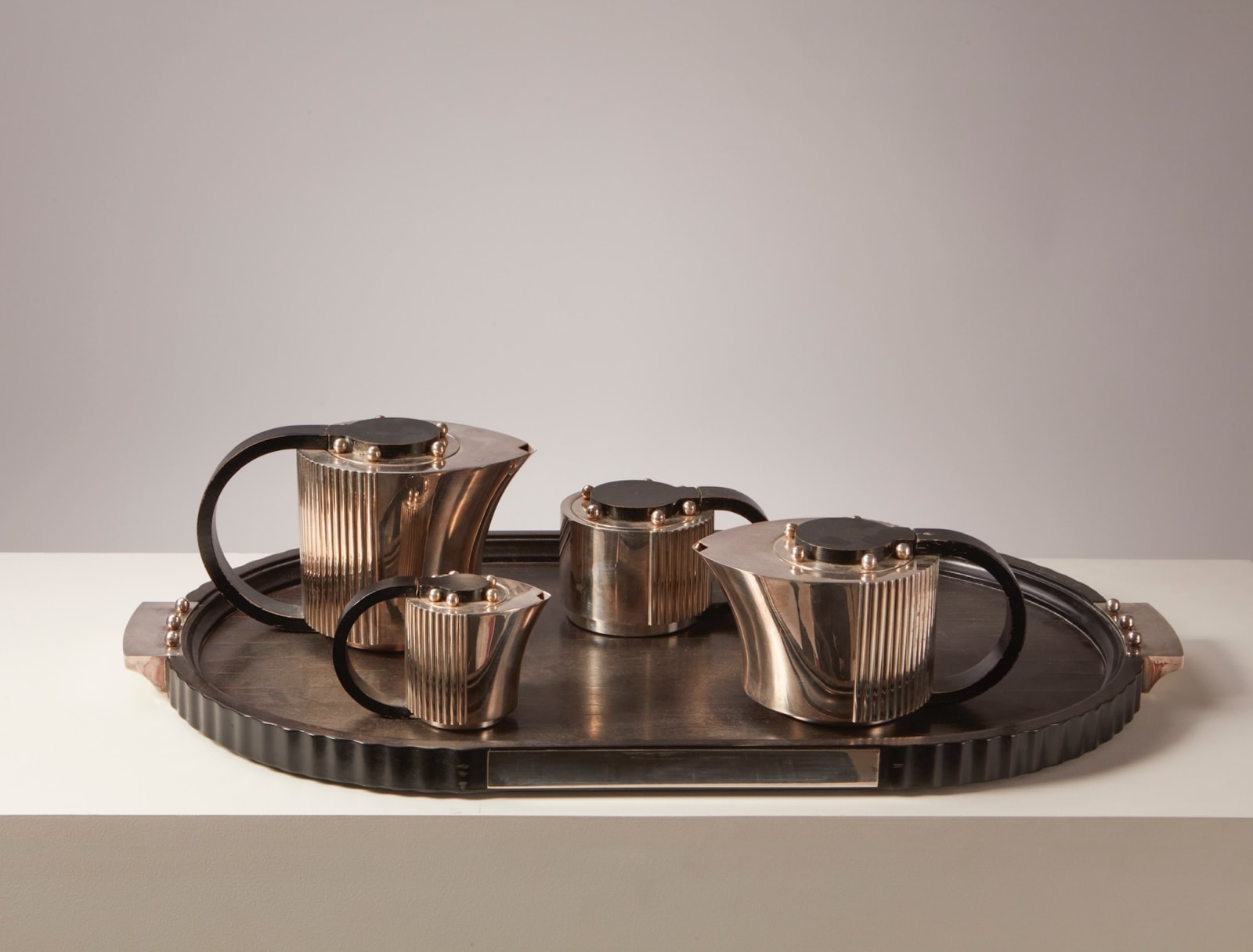 JEAN PUIFORCAT, FOUR-PIECE 'ETCHÉA' TEA SERVICE ON THE TRAY, c. 1937
