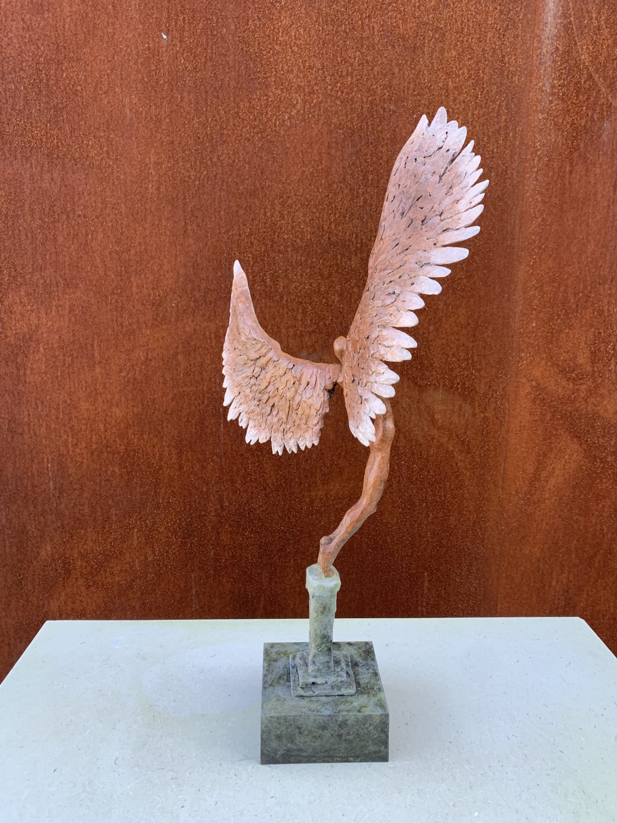 Bronze sculpture of mythical Greek winged figure Icarus by Nicola Godden, displayed on integral plinth