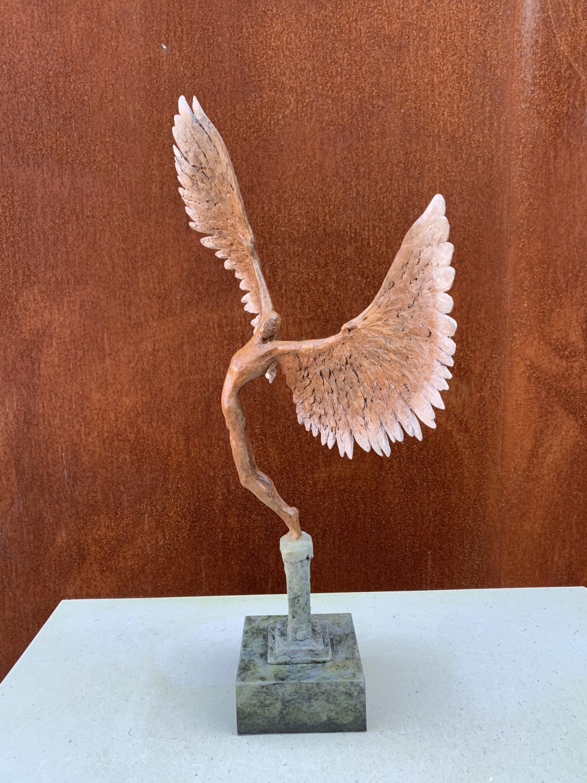 Bronze sculpture of mythical Greek winged figure Icarus by Nicola Godden, displayed on integral plinth