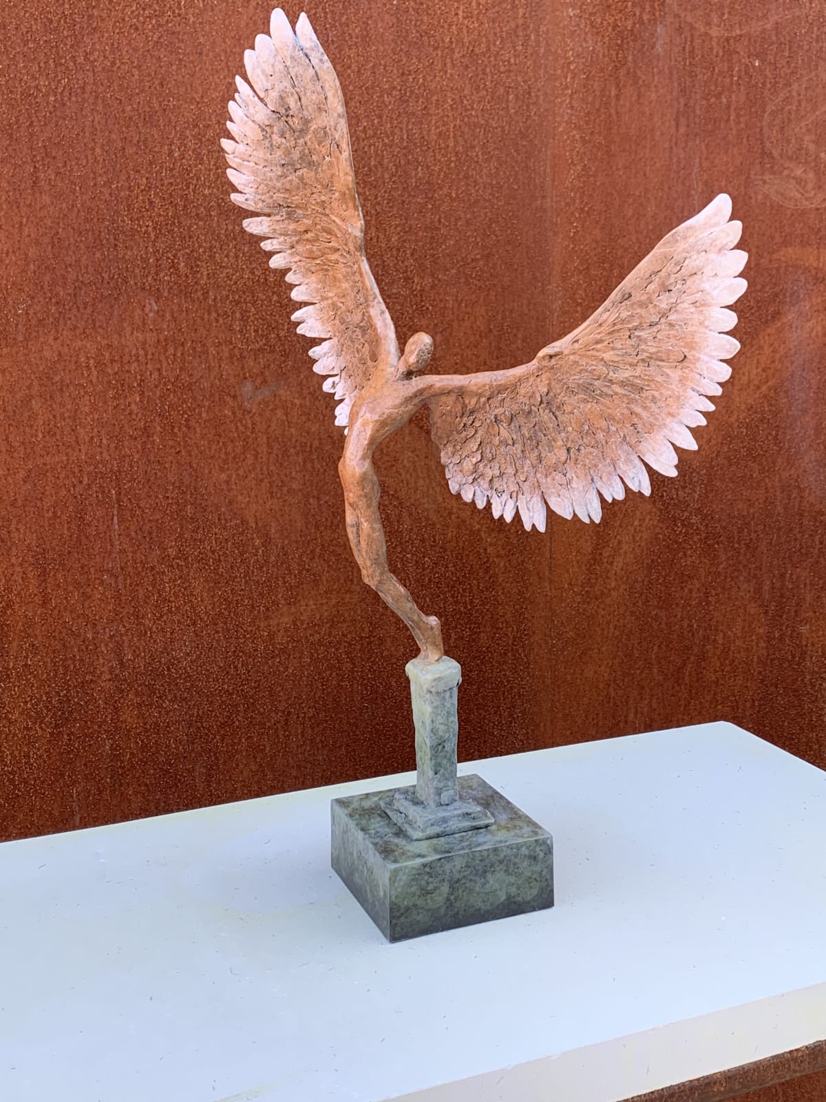 Bronze sculpture of mythical Greek winged figure Icarus by Nicola Godden, displayed on integral plinth