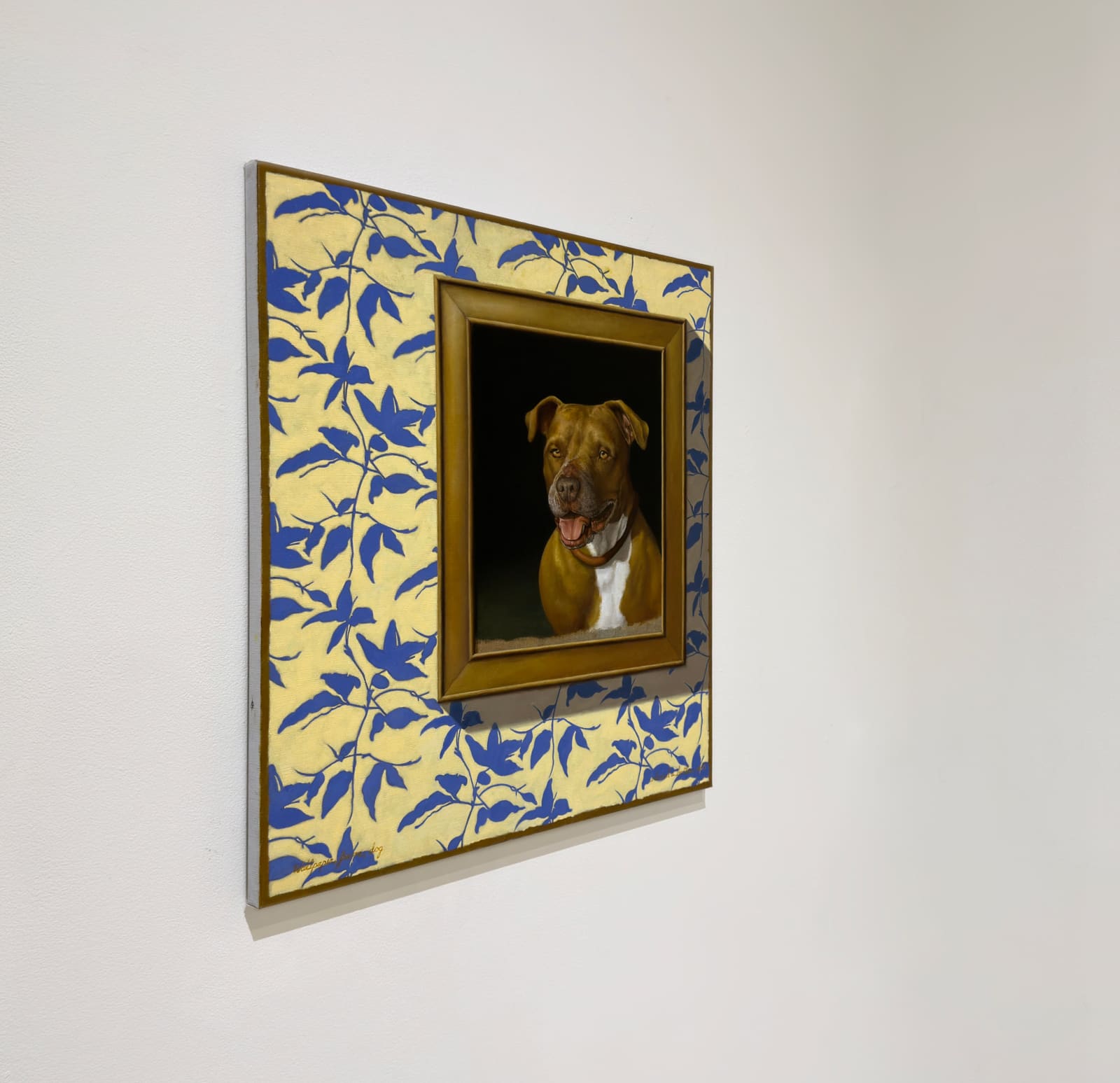 Painting depicting a framed image of a dog on blue floral wallpaper