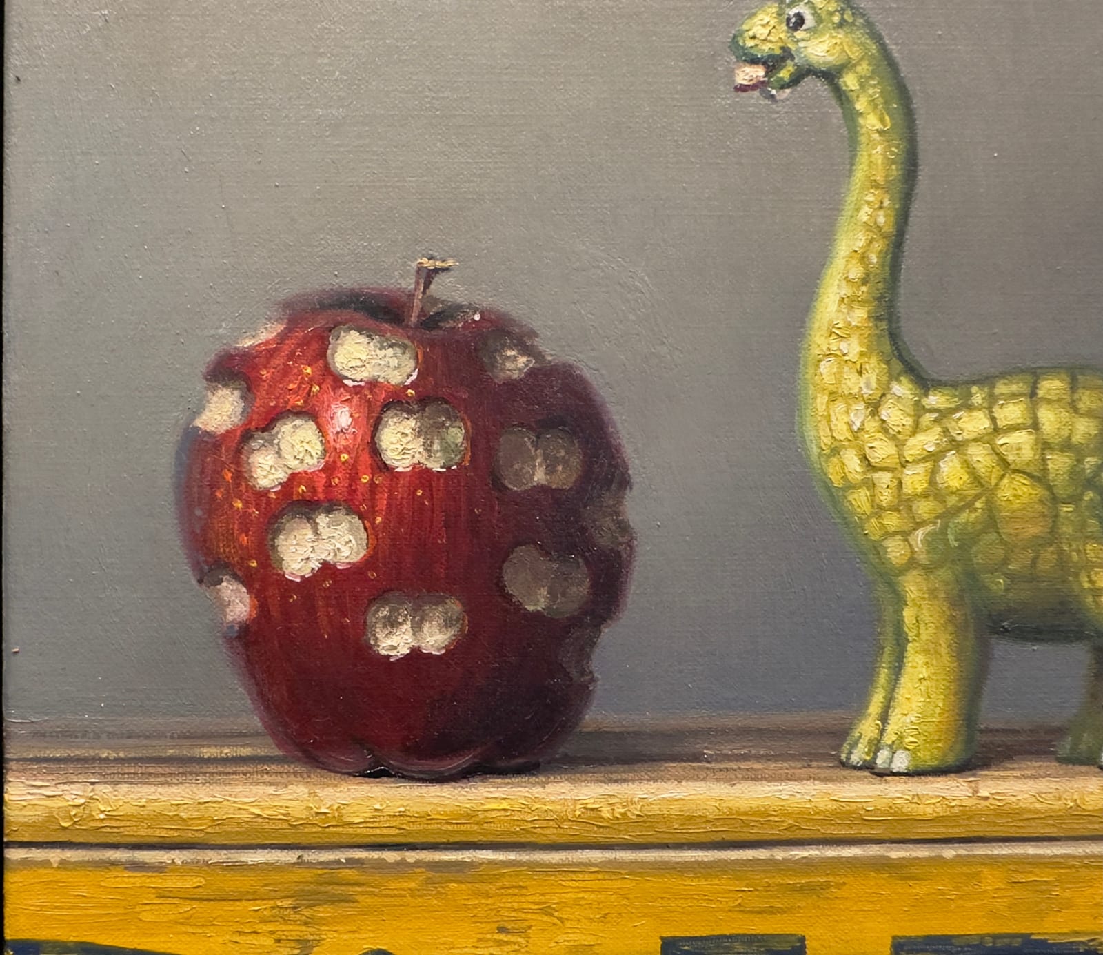 Painting of a dinosaur with a bit apple beside it, all surrounded by a bitten frame
