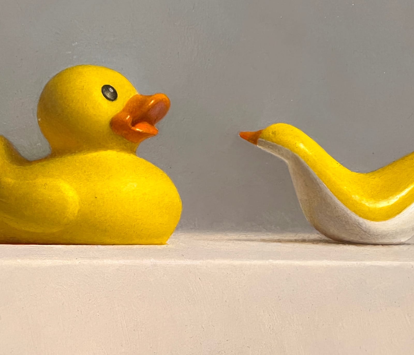 Detail of Rubber duck facing plastic minimalist duck
