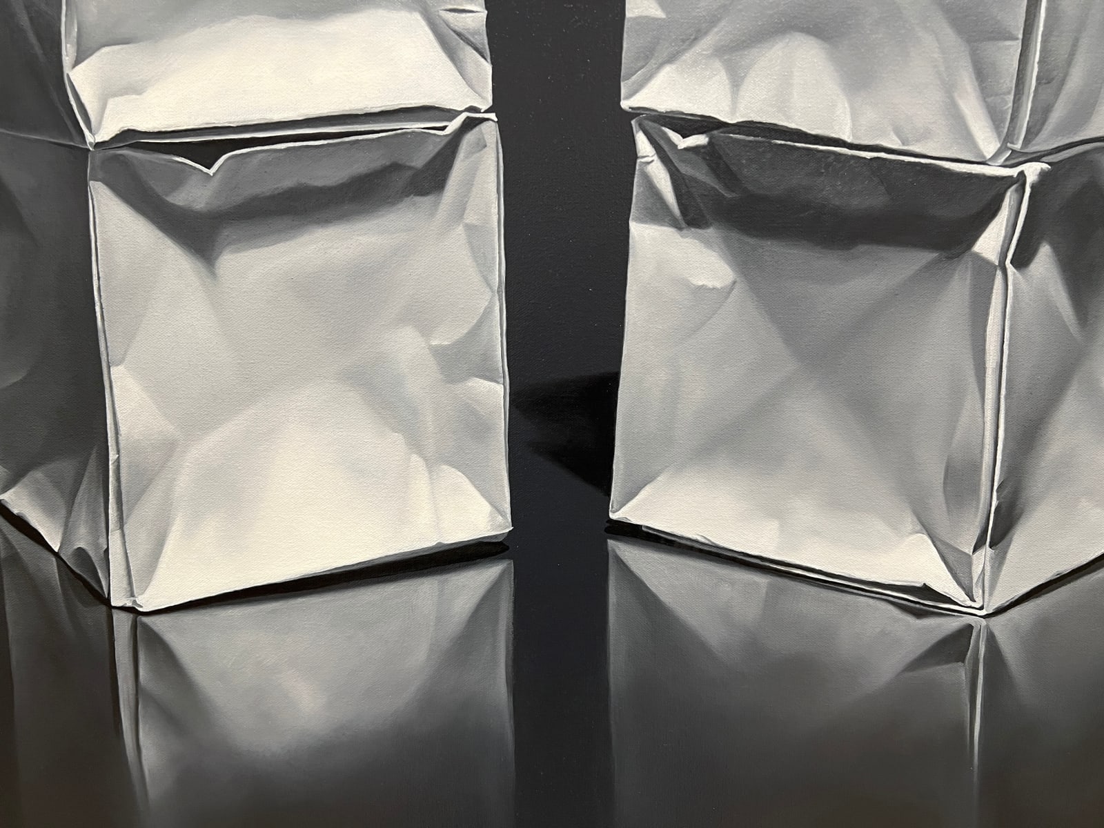 Two origami paper cube columns before black background