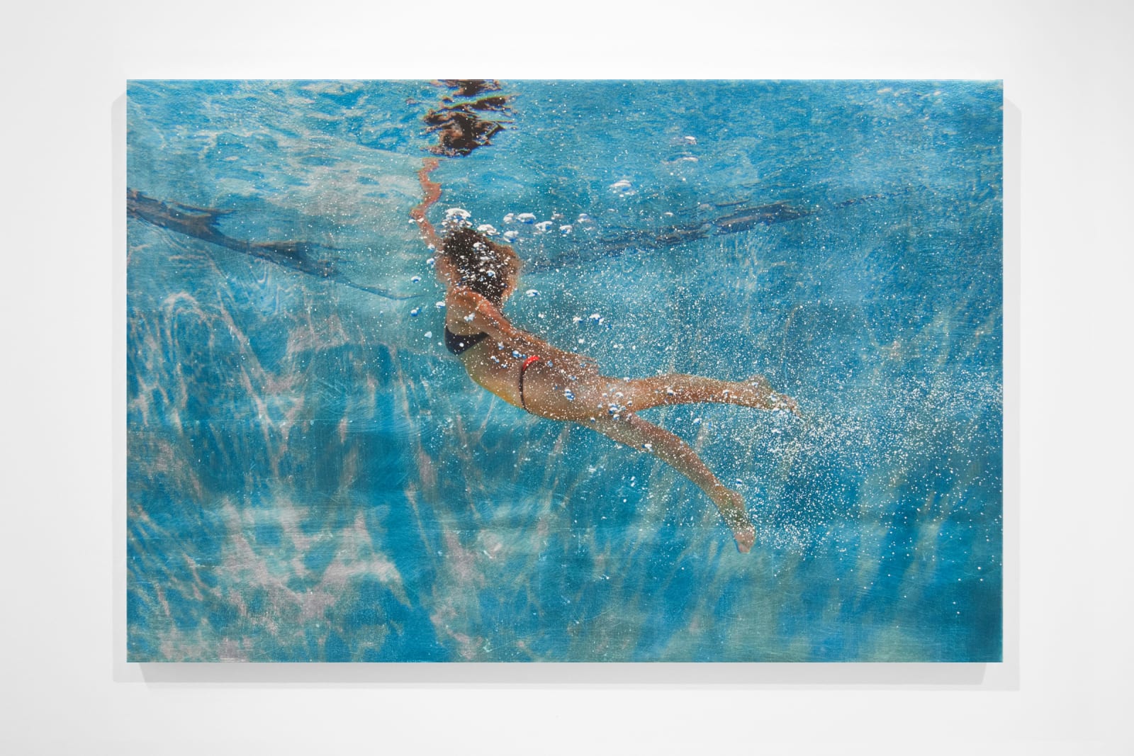 Girl reaching towards water surface