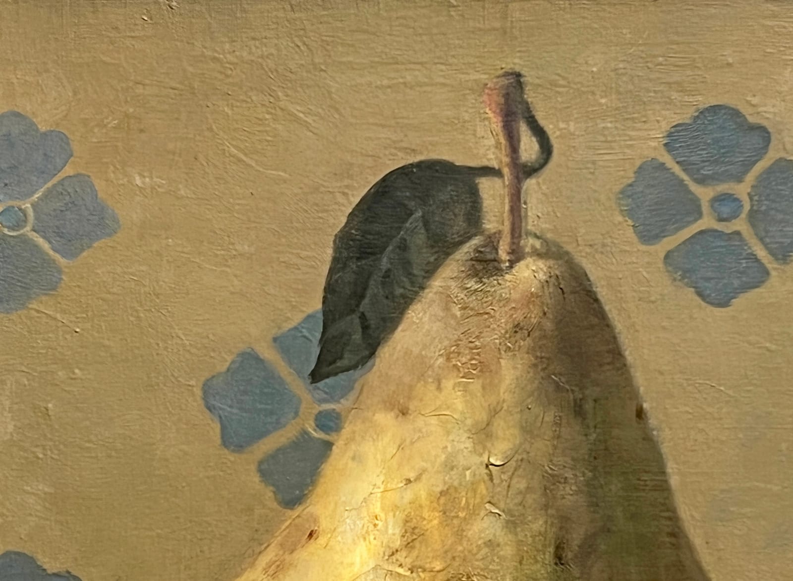 Pear sitting on table with blue design in background