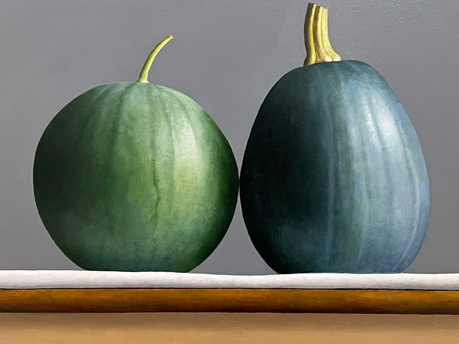Detail of Watermelon and zucchini sitting on table barely touching