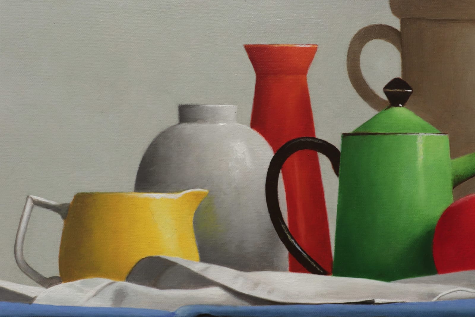 Kettles, bowls, and apples organized on blue green and yellow cloths